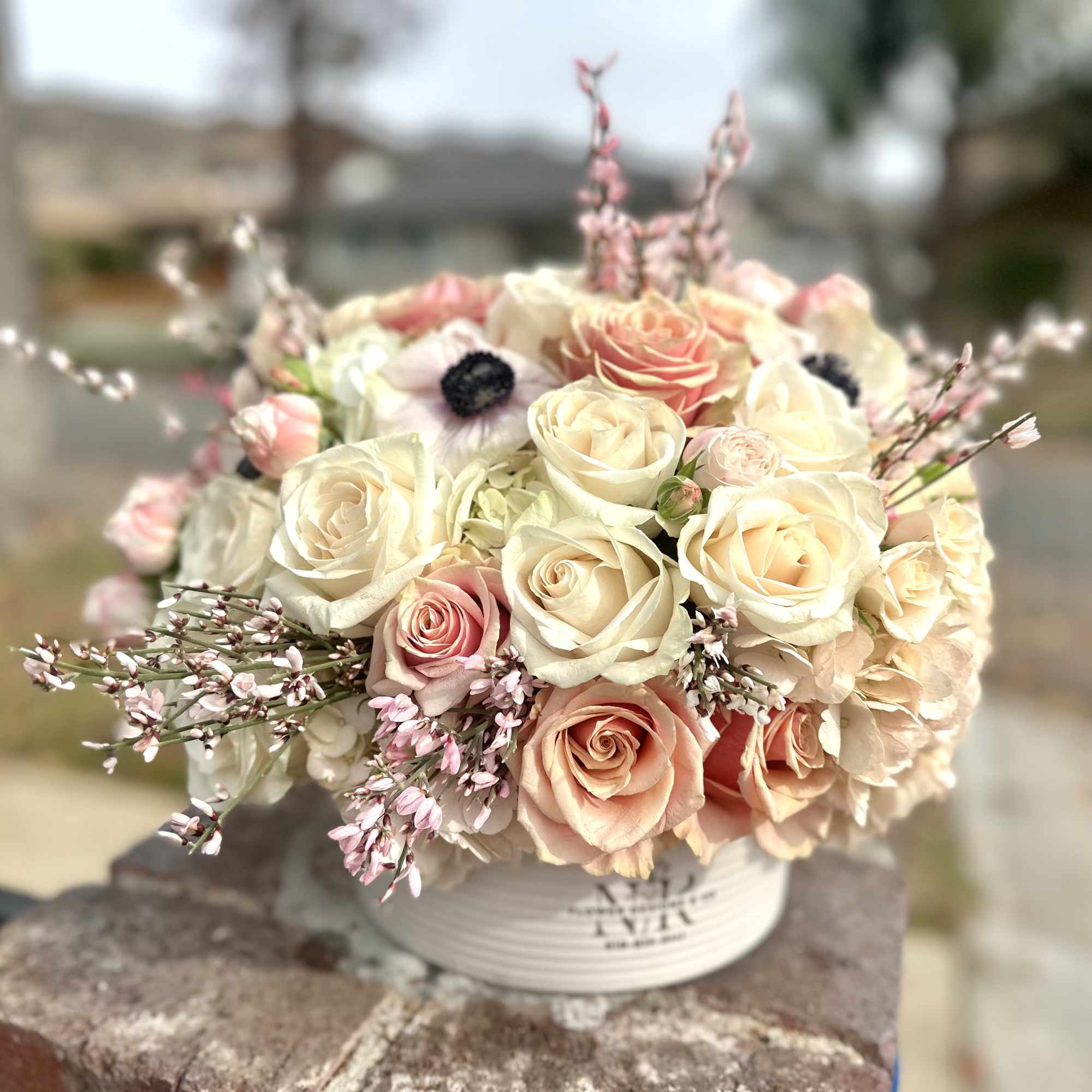 Delicate color combination of freshest flowers in a white ceramic container -