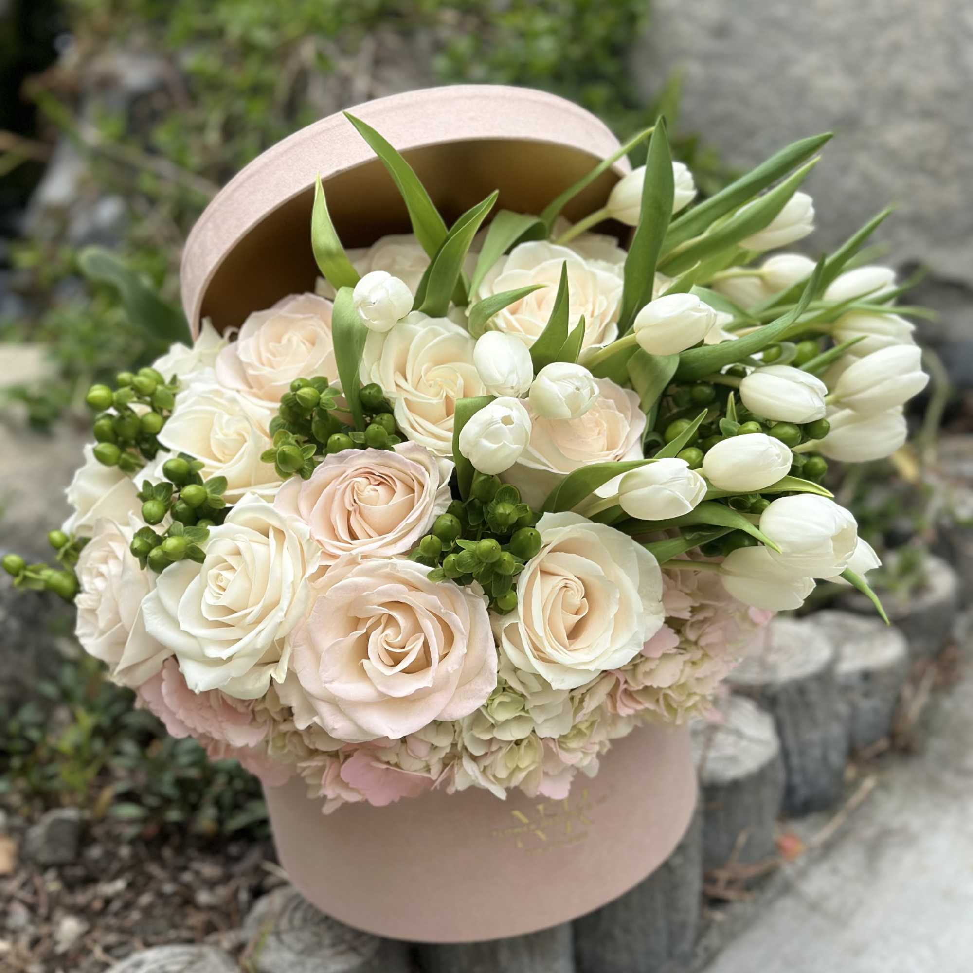 Luxury velvet box filled with white and blush blooms. 