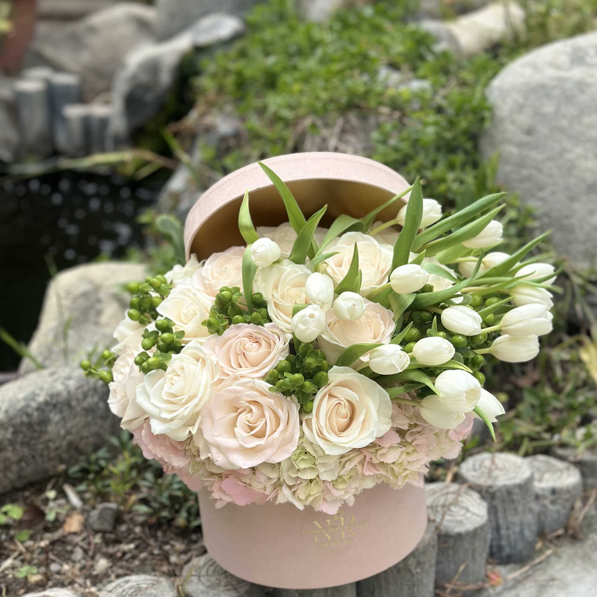 Luxury velvet box filled with white and blush blooms. 
