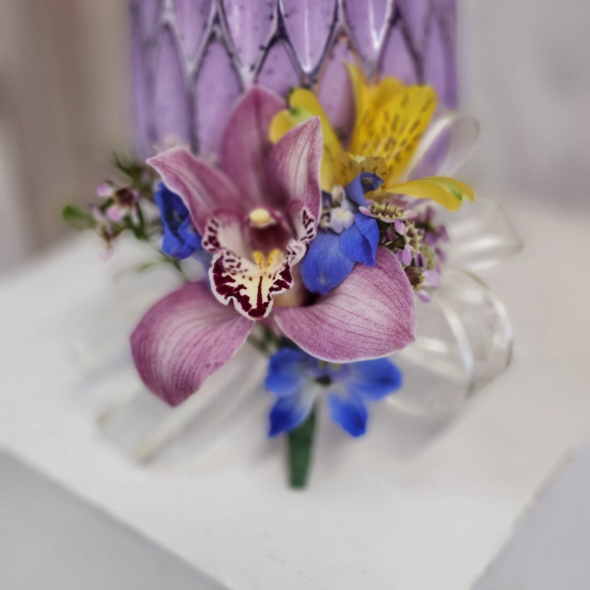 Have your special mom wear a beautiful floral boutanierre of cymbidium orchid