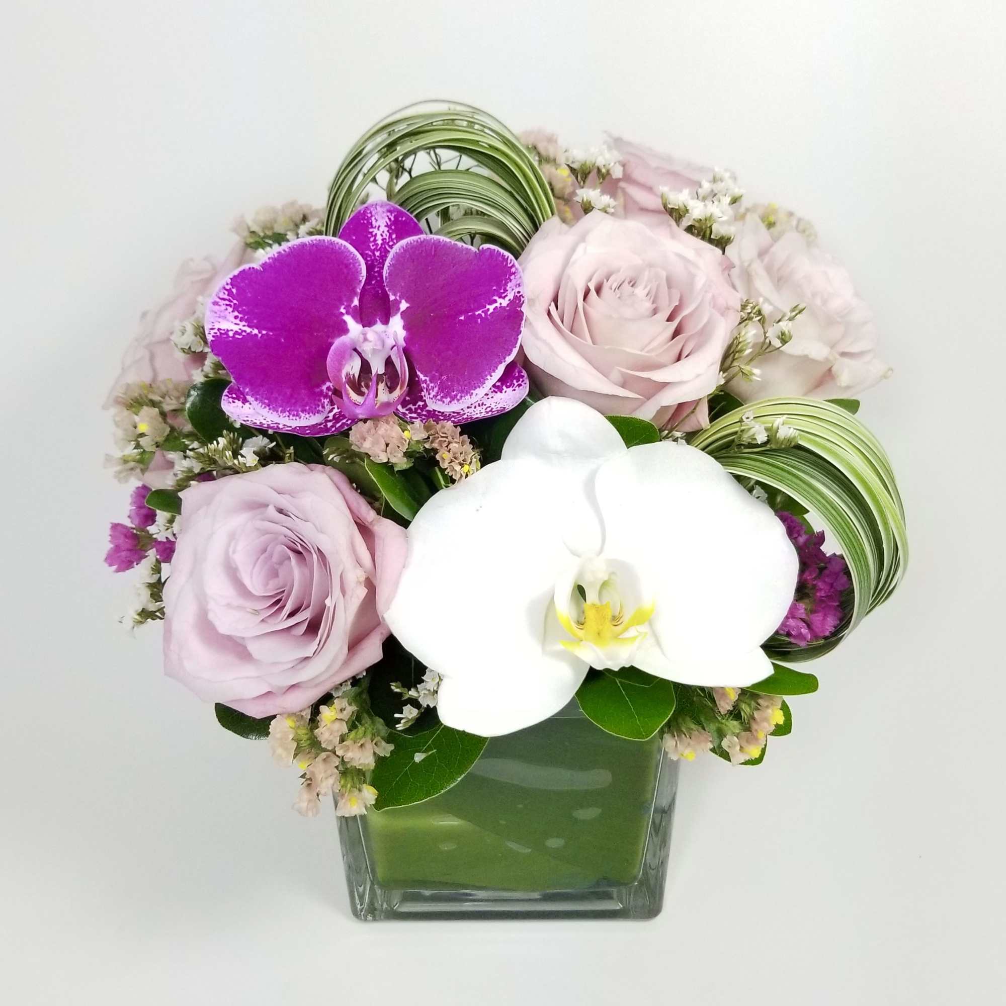 Beautiful arrangement of premium pink roses, Statice, Phalaenopsis Orchids, Lily Grass, greenery Beautiful arrangement of premium pink roses, Statice, Phalaenopsis Orchids, Lily Grass, greenery