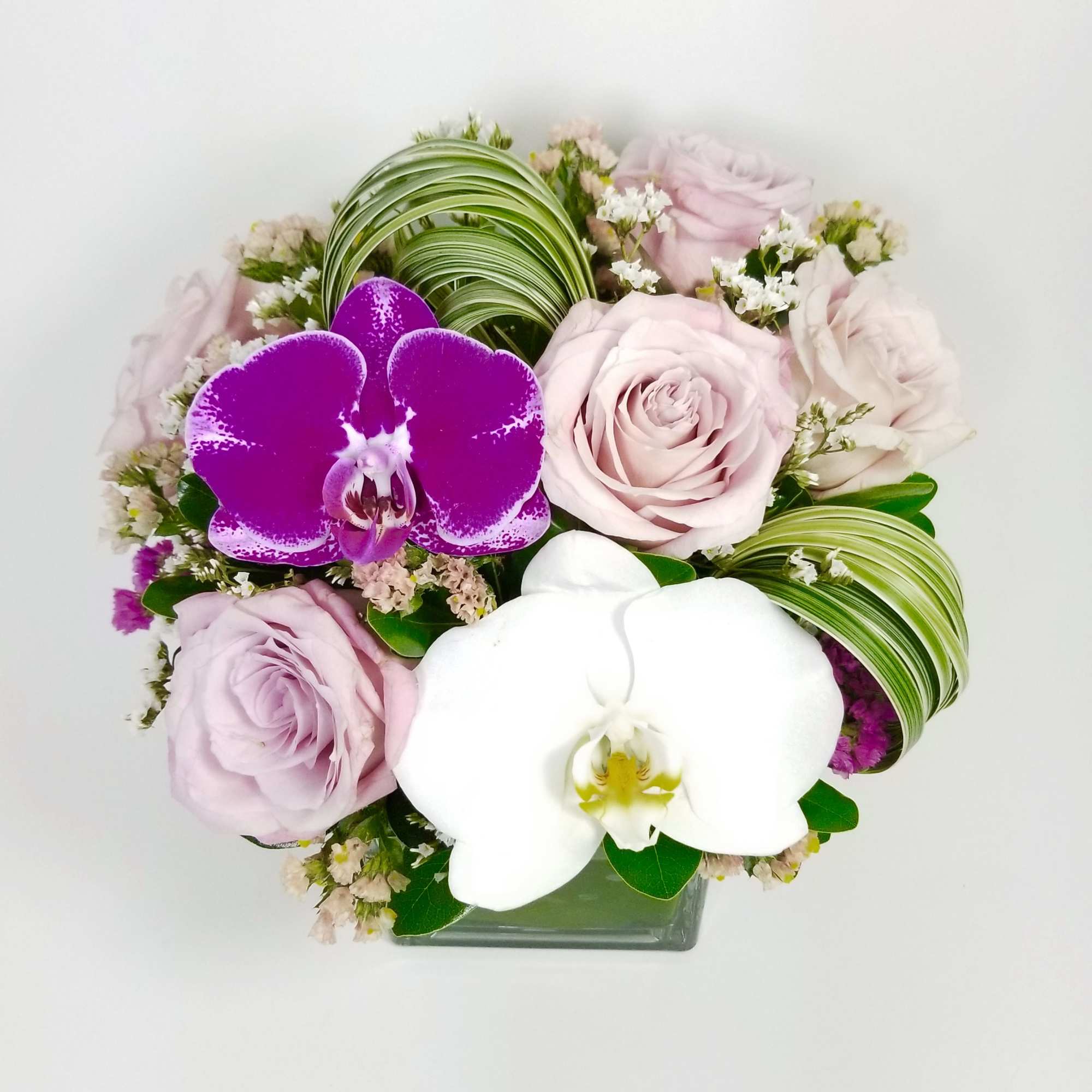 Beautiful arrangement of premium pink roses, Statice, Phalaenopsis Orchids, Lily Grass, greenery Beautiful arrangement of premium pink roses, Statice, Phalaenopsis Orchids, Lily Grass, greenery