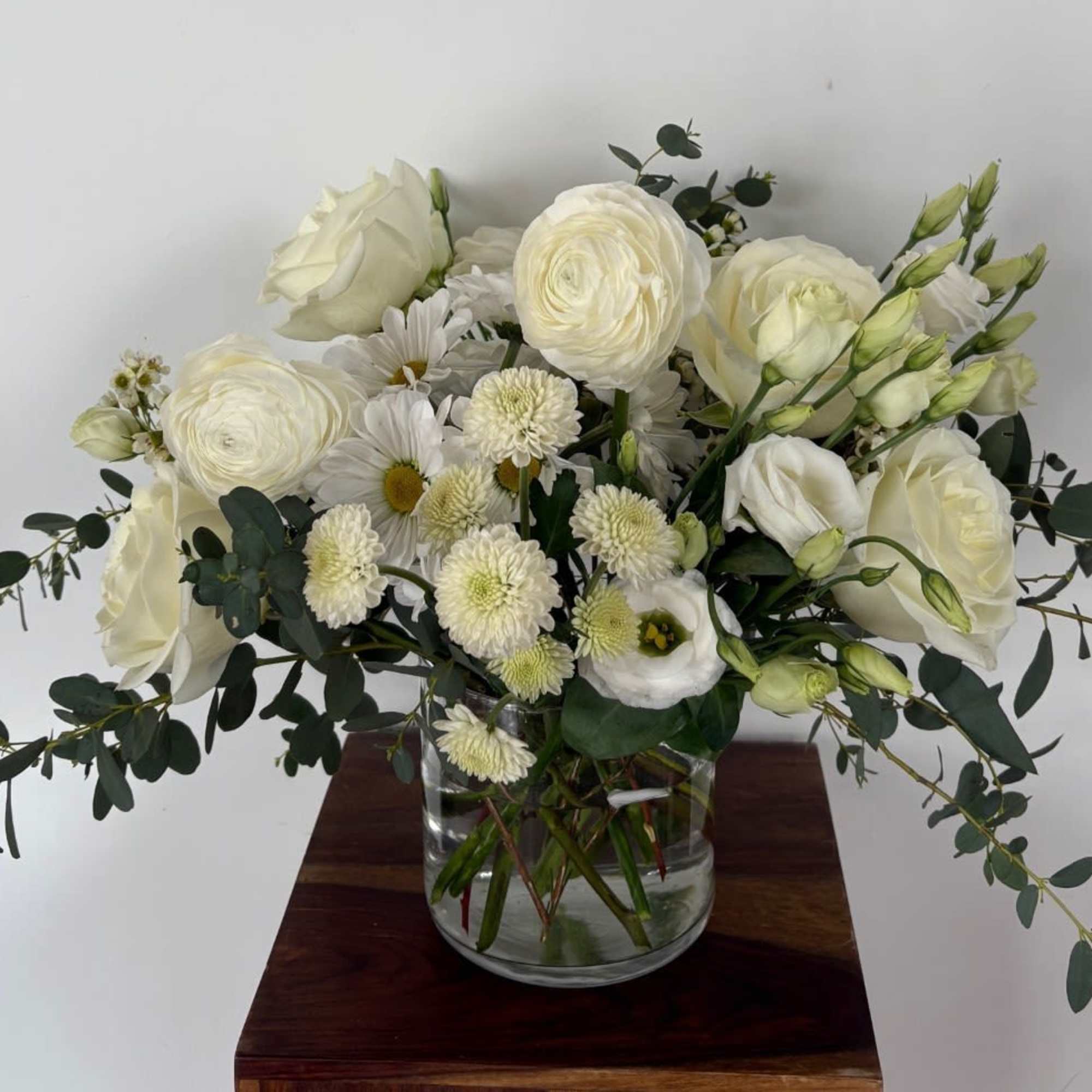 A mix of designer&rsquo;s choice white blooms to include premium stems of