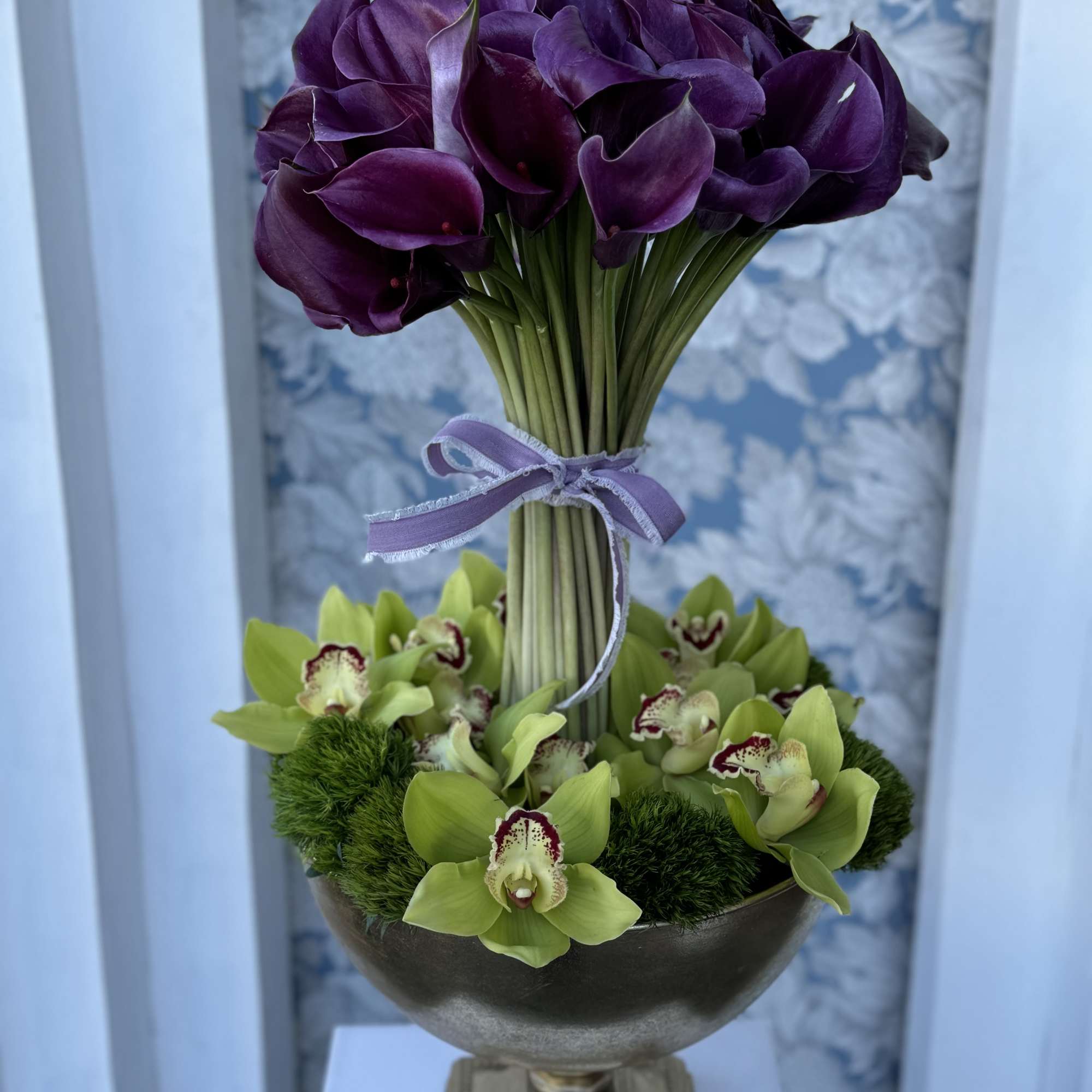 Calla Lilies Arrangement with  Cymbidium Orchids beautifully designed in the vase