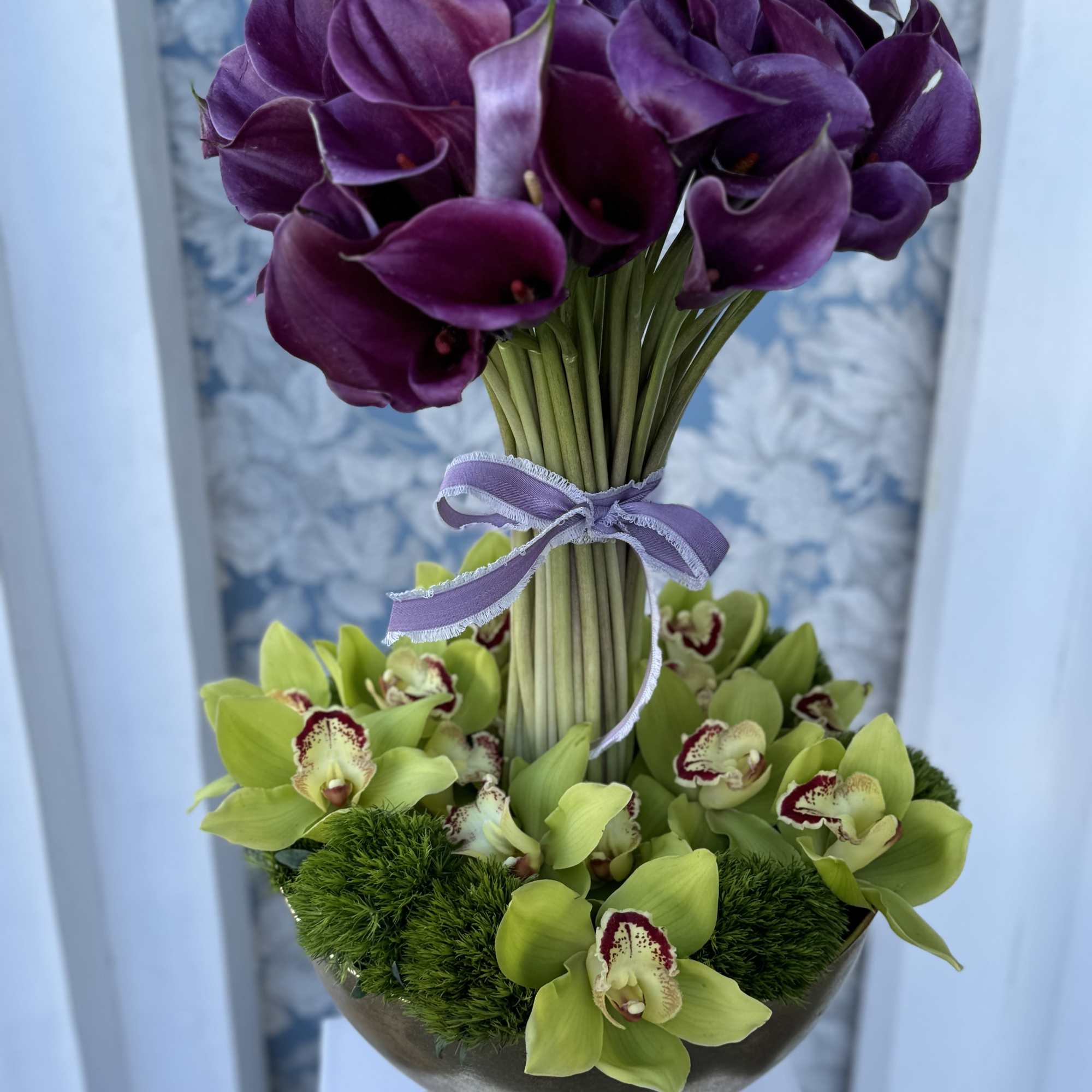 Calla Lilies Arrangement with  Cymbidium Orchids beautifully designed in the vase