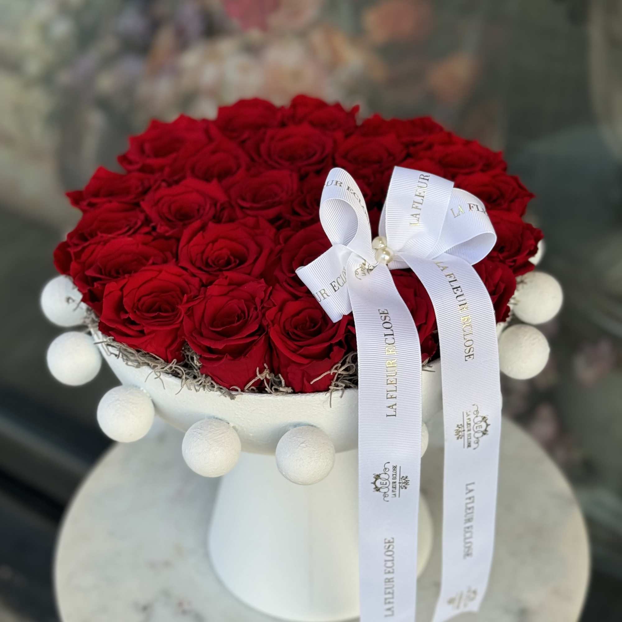 An elegant crown of preserved red roses, arranged in a heart shape An elegant crown of preserved red roses, arranged in a heart shape