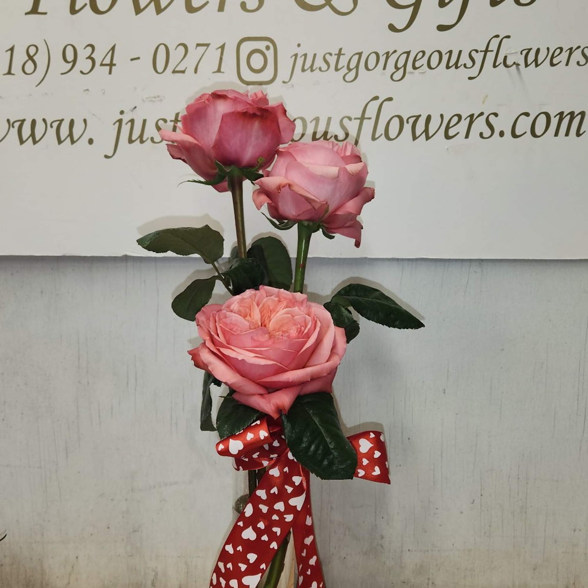 A sweet trio of fresh roses arranged in a charming bud vase. A sweet trio of fresh roses arranged in a charming bud vase.