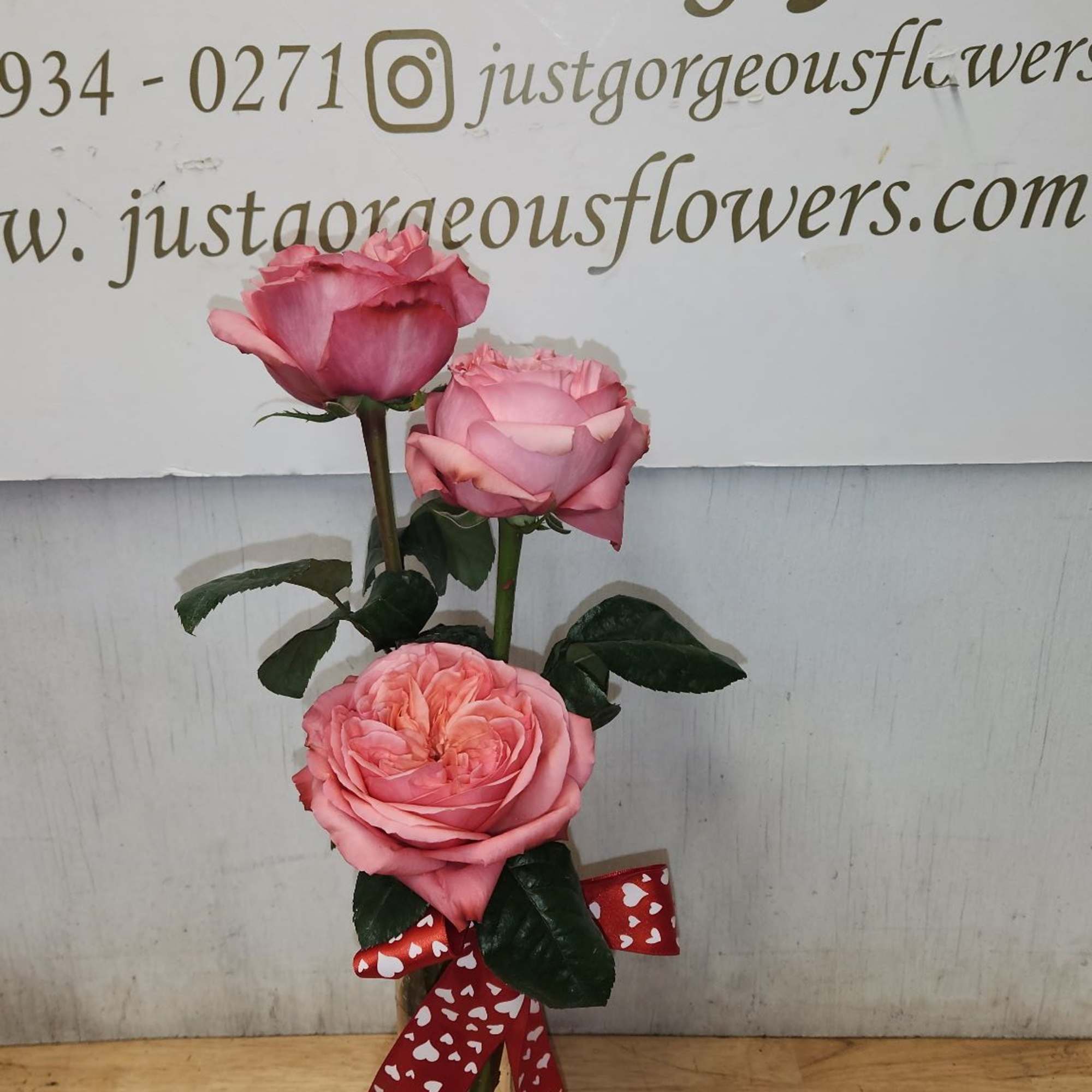A sweet trio of fresh roses arranged in a charming bud vase. A sweet trio of fresh roses arranged in a charming bud vase.
