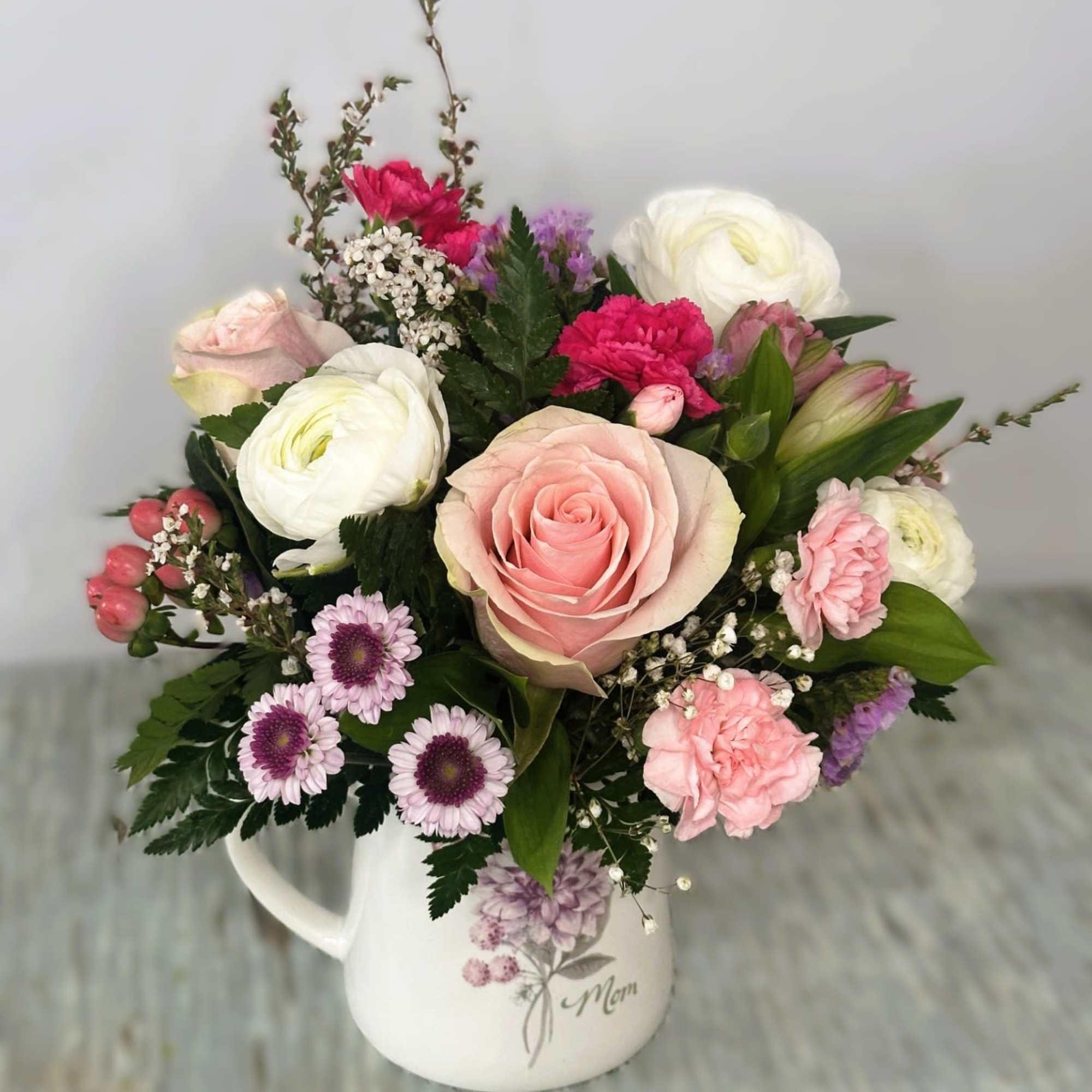 Arrangement designed in an 16oz Ceramic mug with a lavender and pink Arrangement designed in an 16oz Ceramic mug with a lavender and pink