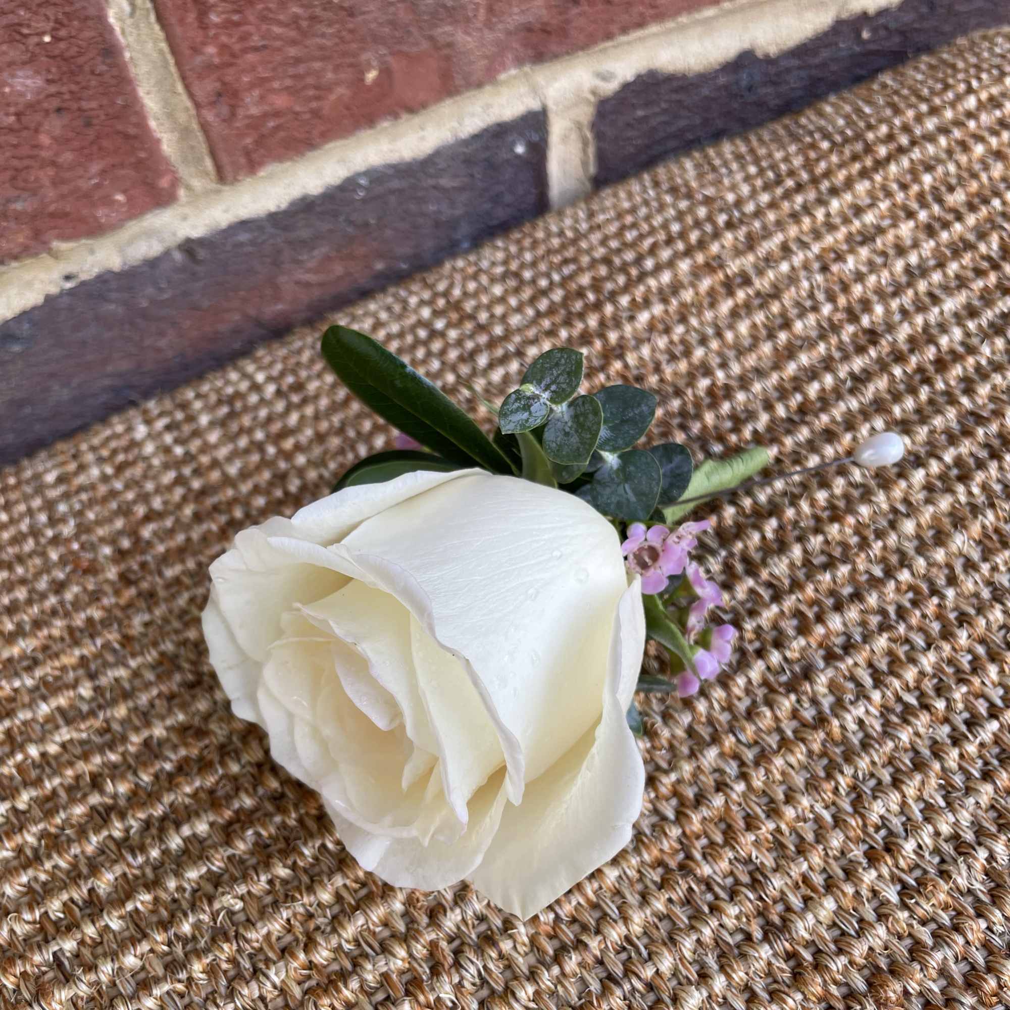 A white rose boutonniere for him. Perfect for prom and weddings. 
Note: