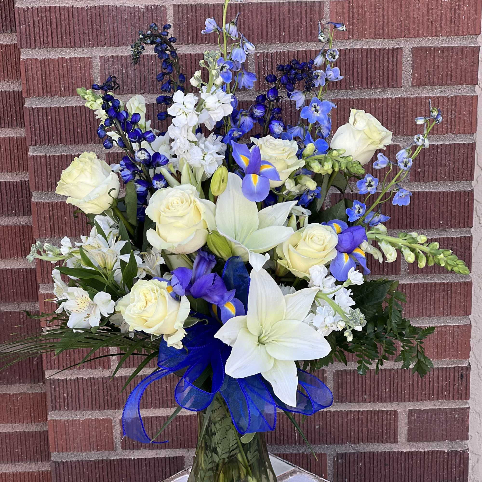 Featuring lilies, roses, stock, iris and larkspur.  Featuring lilies, roses, stock, iris and larkspur.