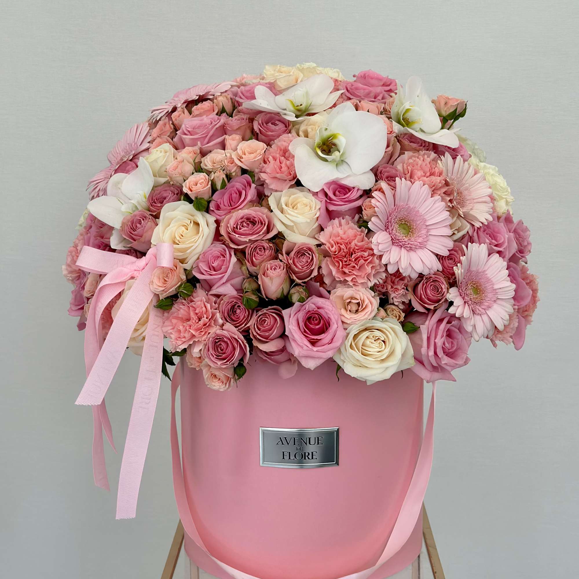 Unveil a touch of elegance with this pink box of beautiful flowers.