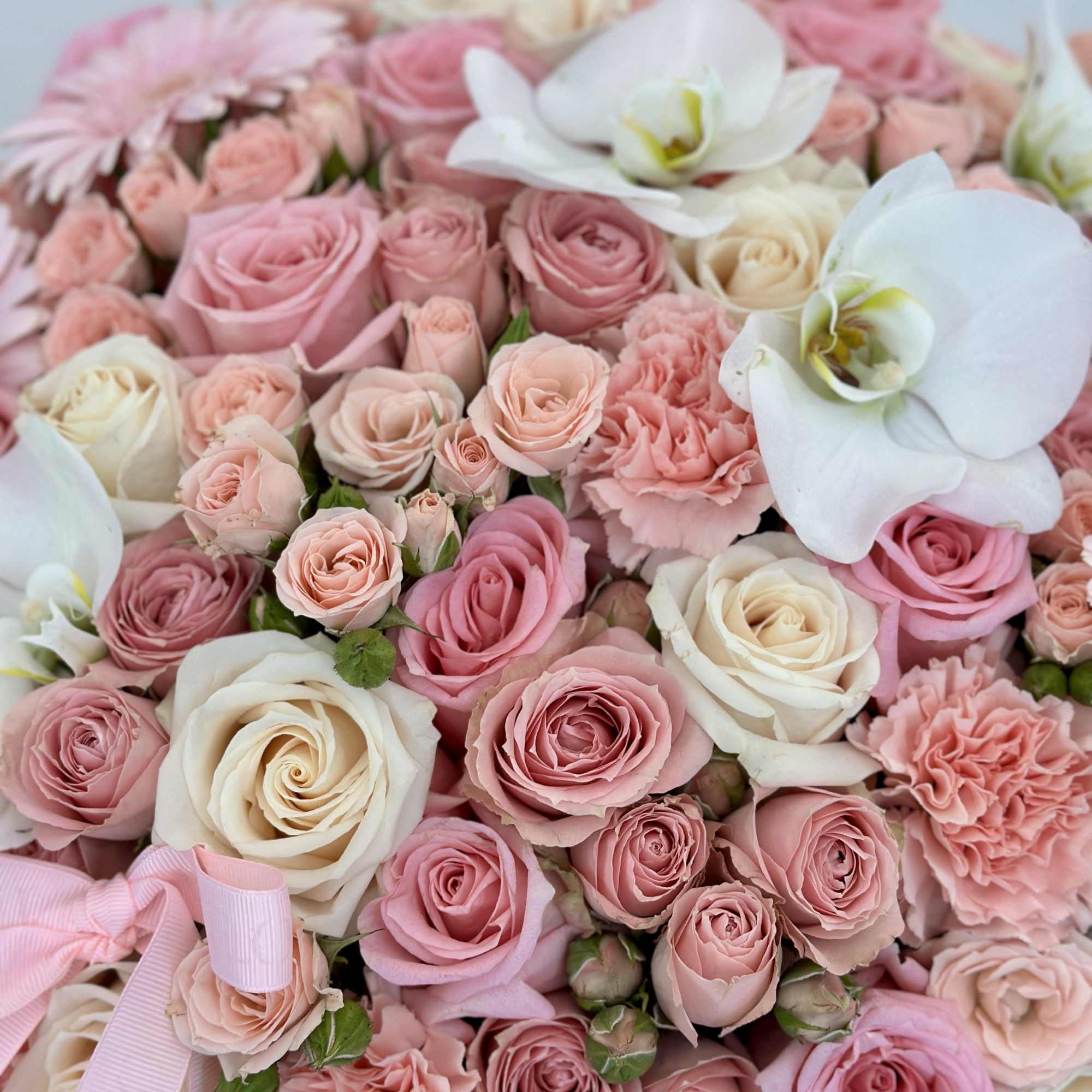 Unveil a touch of elegance with this pink box of beautiful flowers.