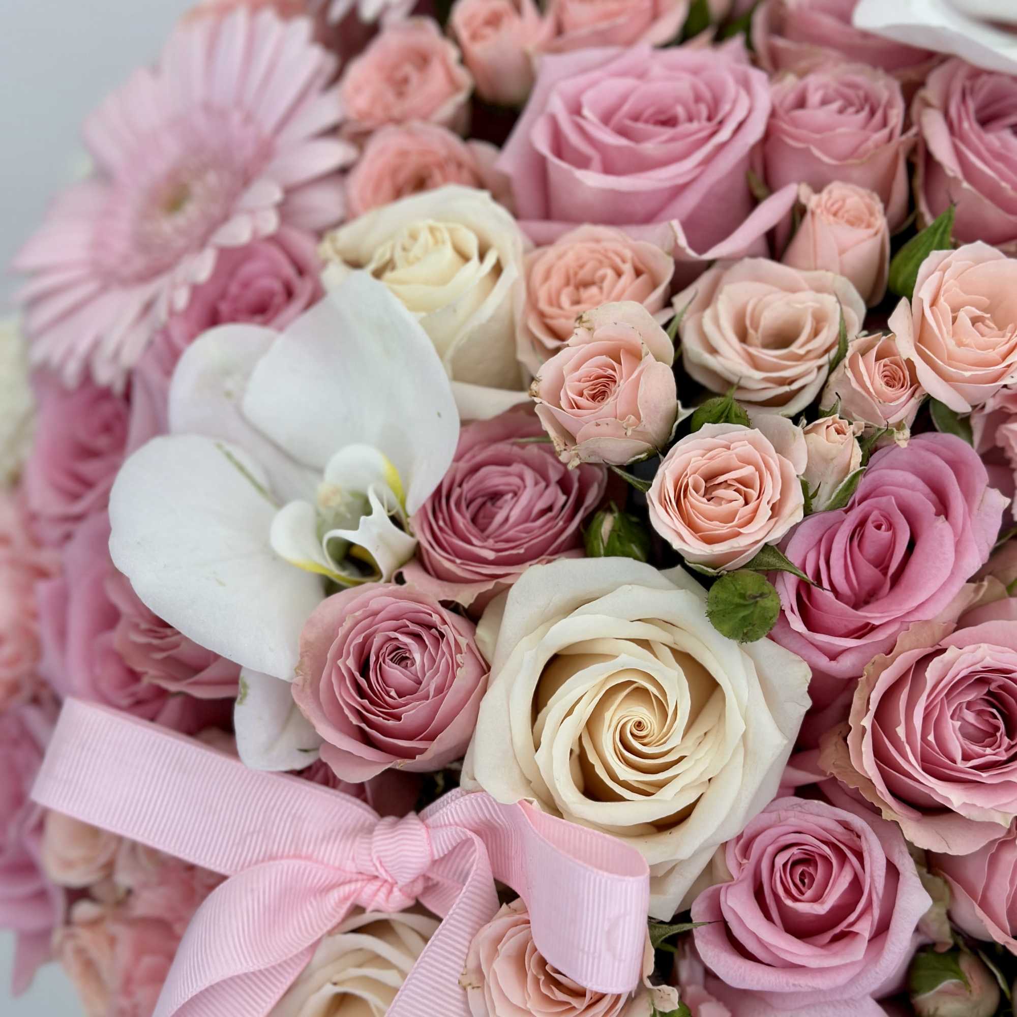Unveil a touch of elegance with this pink box of beautiful flowers.