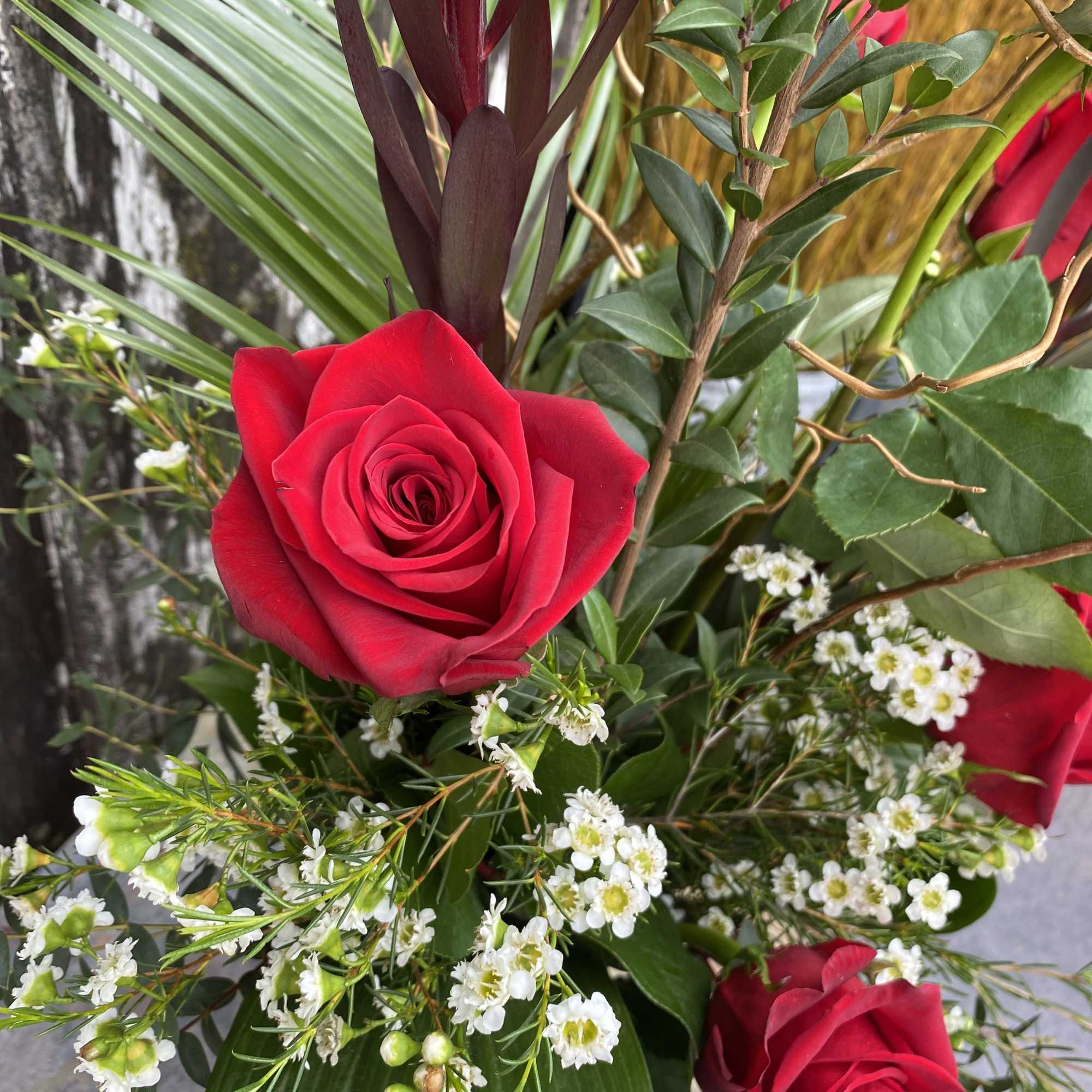 Six roses arranged in a tall glass vase.
To request another color than