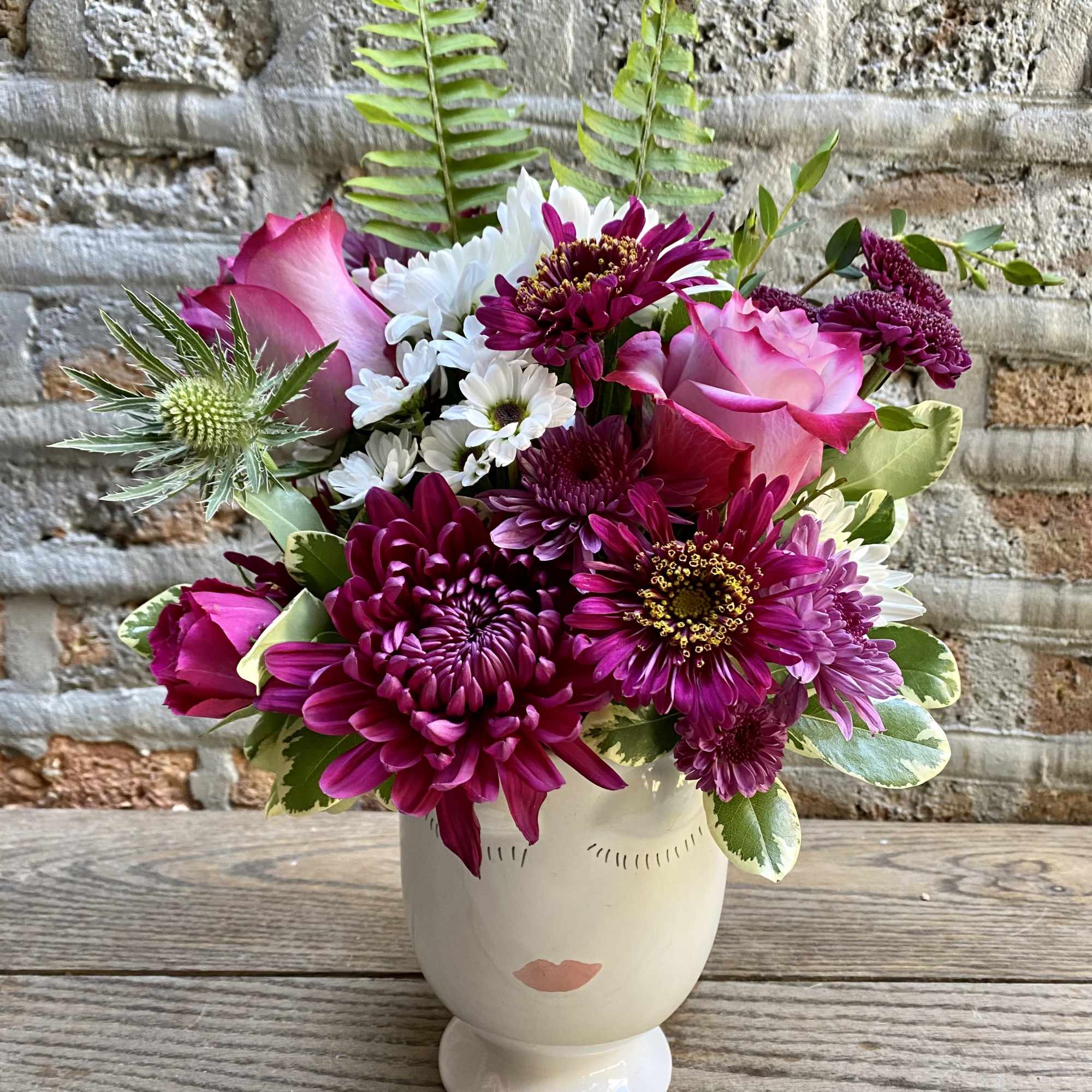 Face vase with floral accents available 2 sizes - flowers will vary