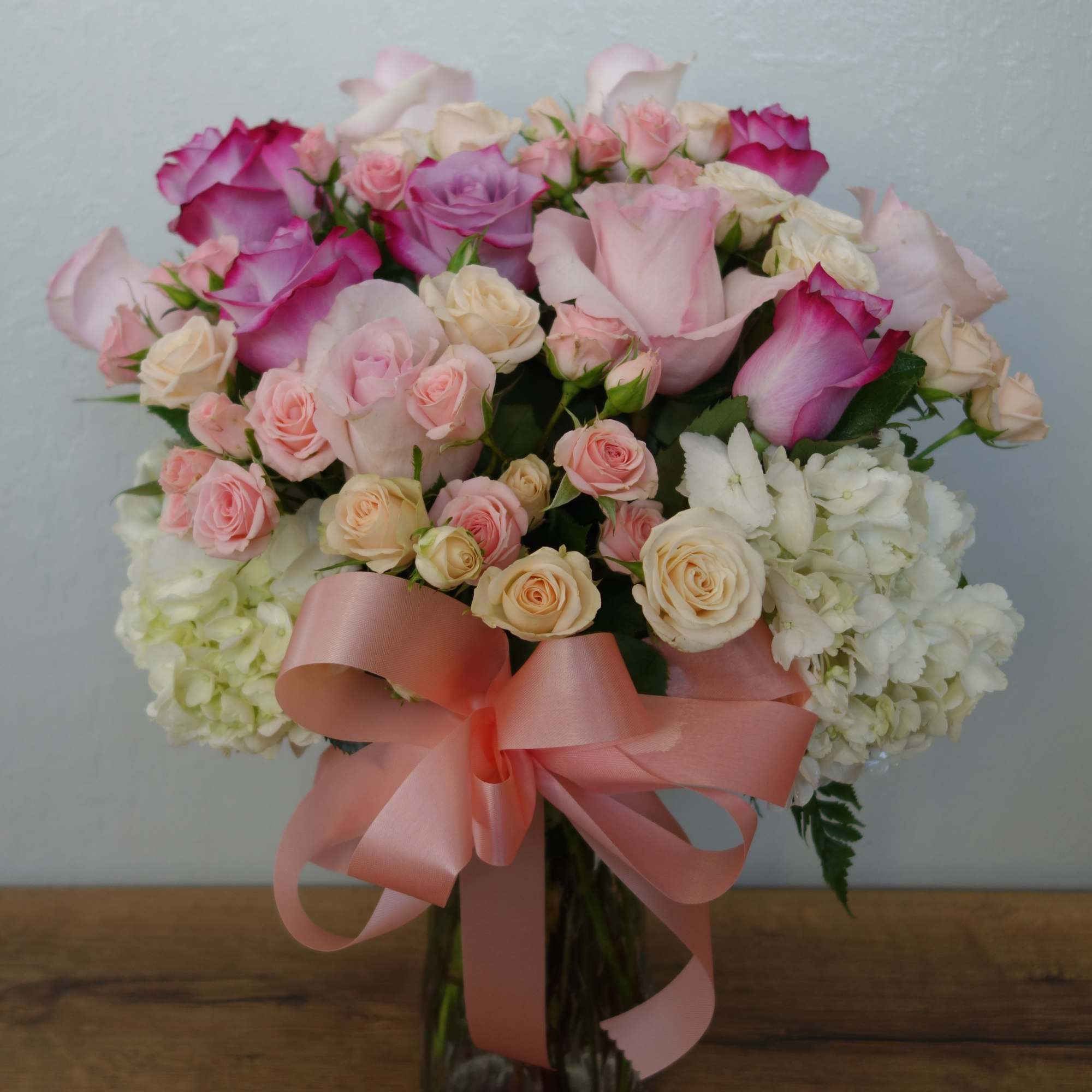 This gorgeous bouquet includes white hydrangea, light pink roses, pink roses, crème This gorgeous bouquet includes white hydrangea, light pink roses, pink roses, crème