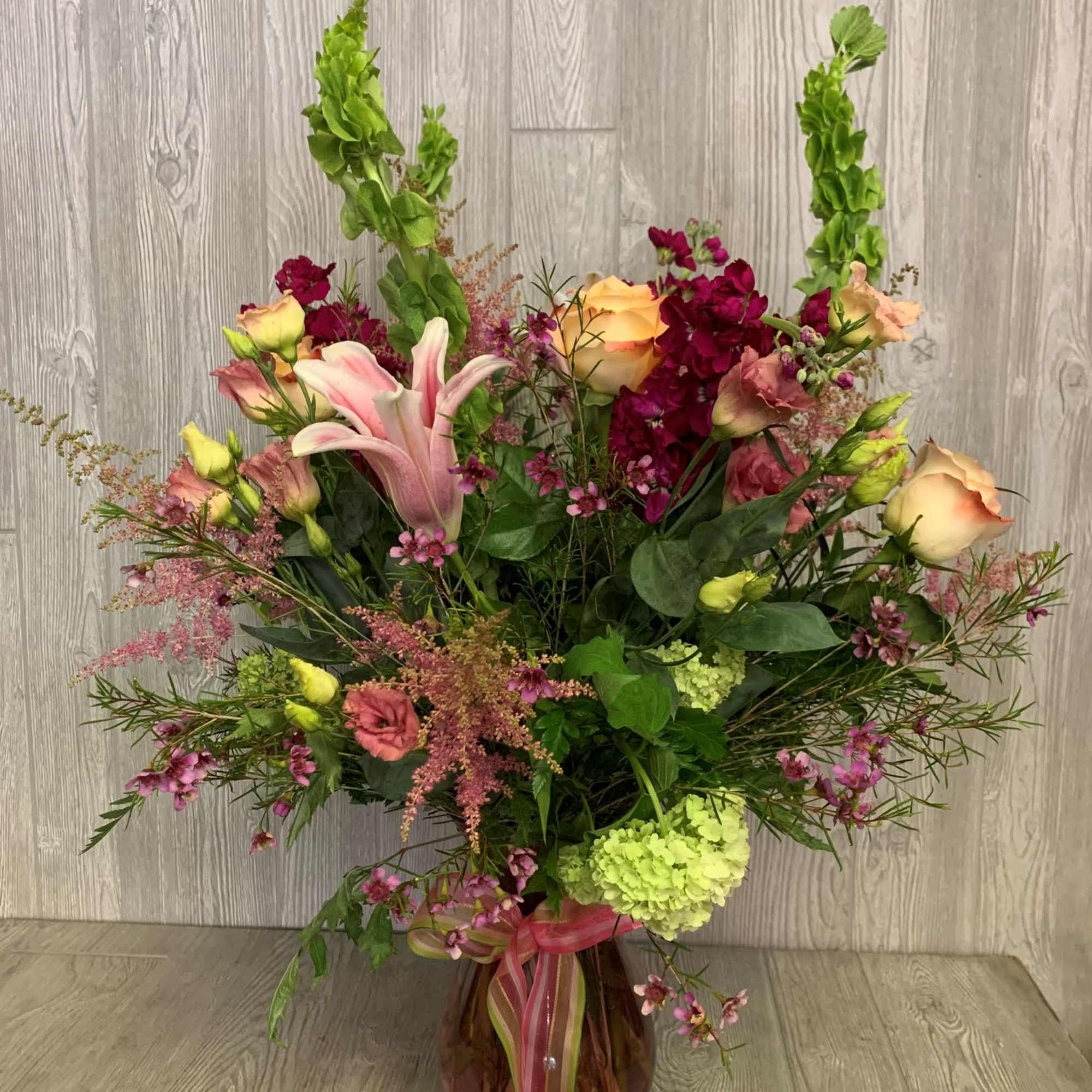 Assorted spring blooms in pinks and greens. Assorted spring blooms in pinks and greens.