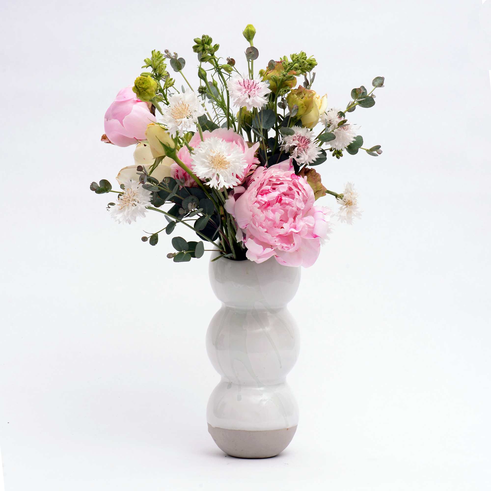 A handmade porcelain vase 12&quot; tall by 4&quot; wide filled with seasonal