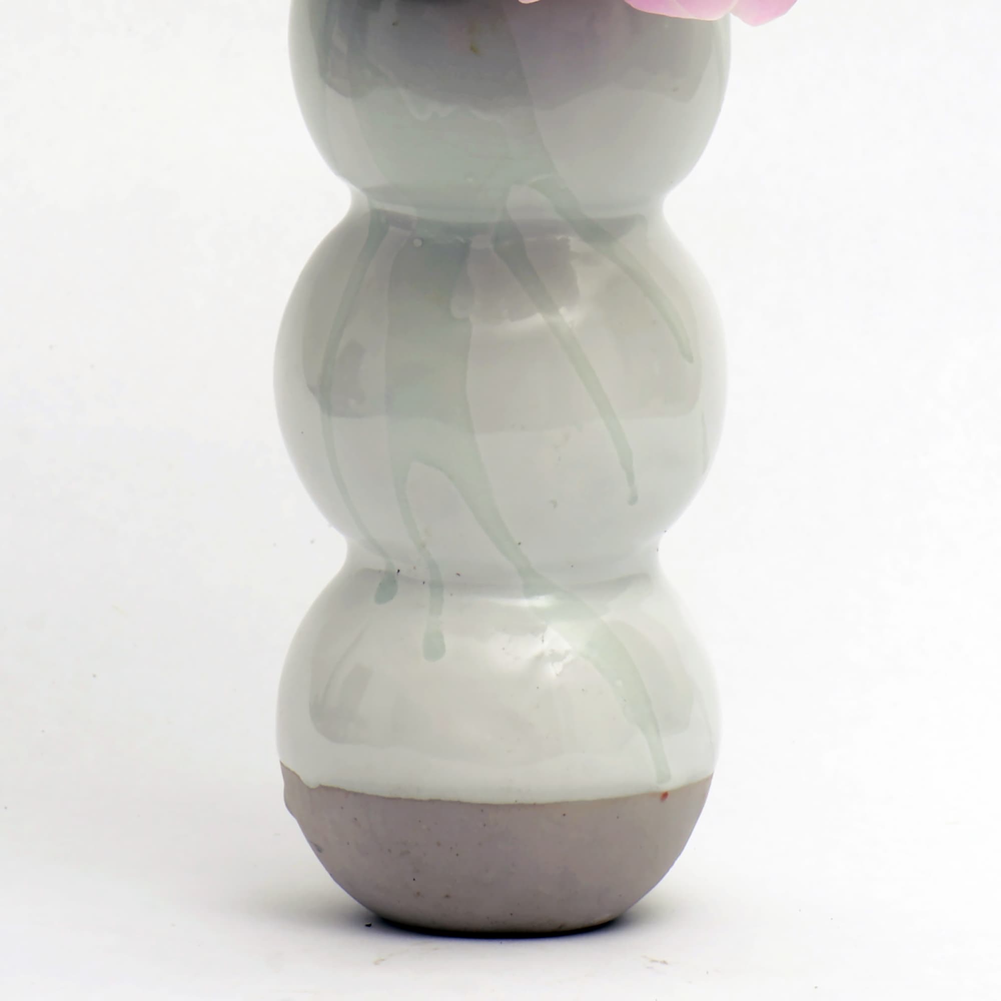 A handmade porcelain vase 12&quot; tall by 4&quot; wide filled with seasonal