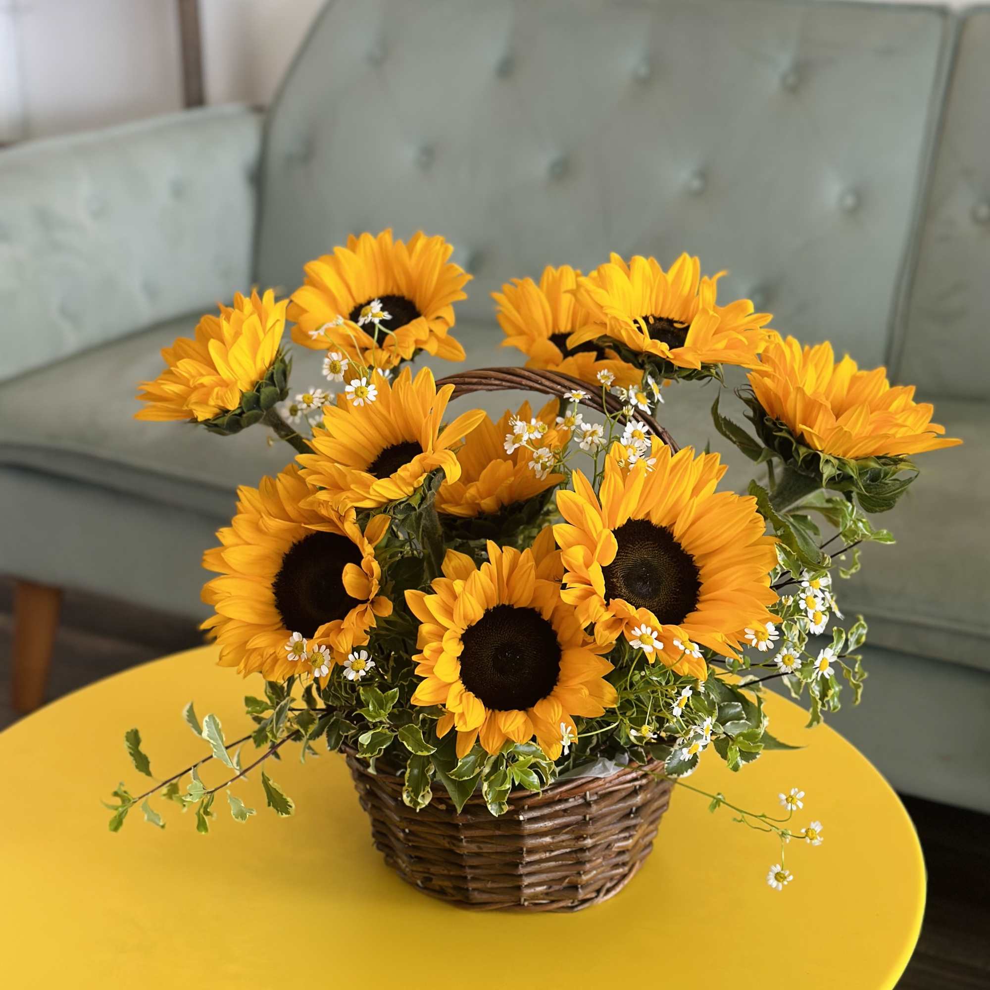 A charming basket with 10 sunflowers, daisies, and greenery.