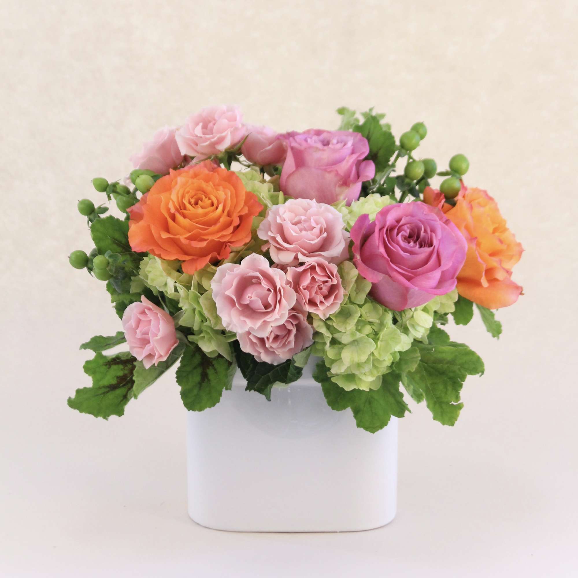 A striking colors of orange, light pink, lavender and lime green flowers