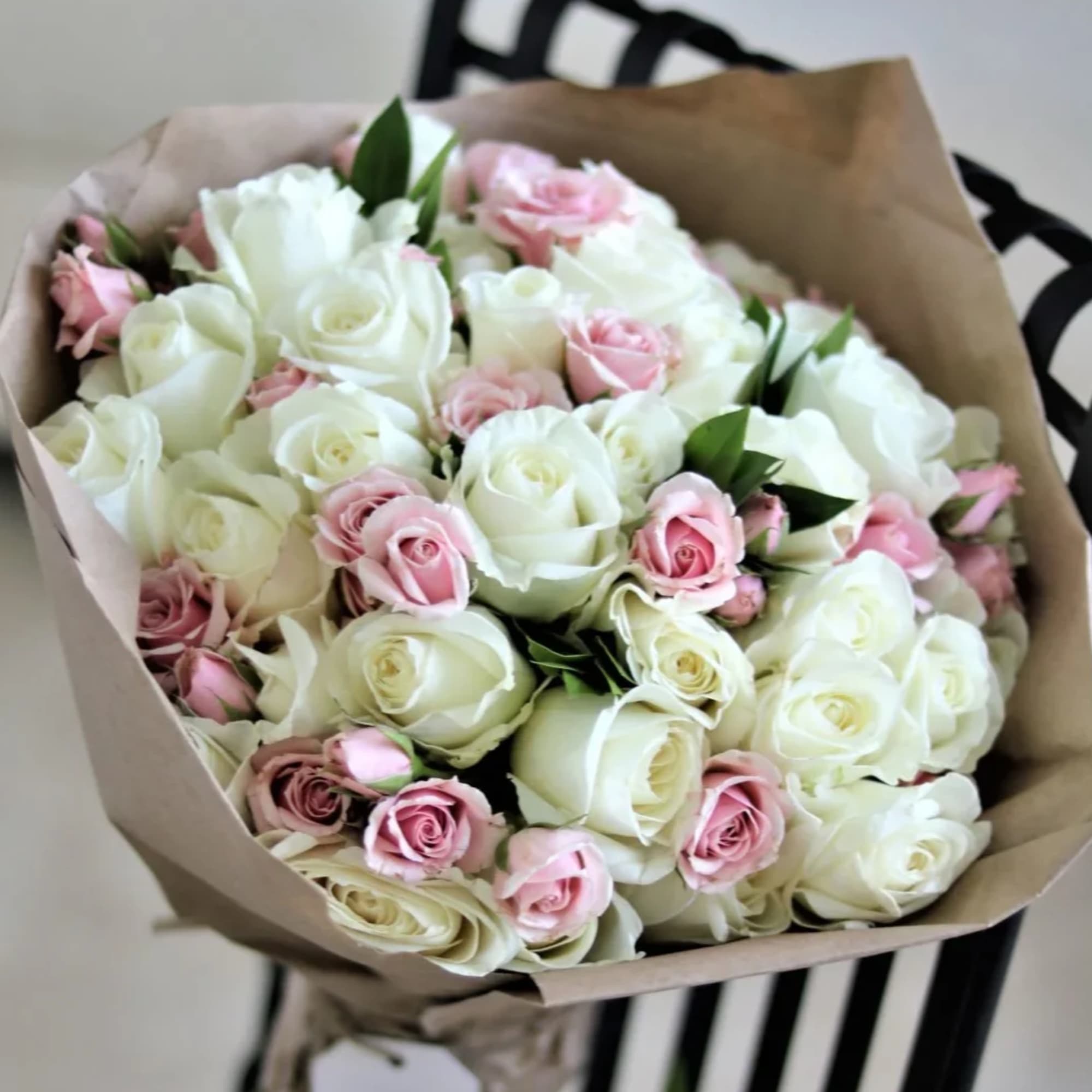 Fifty beautiful roses delicately wrapped in craft paper. Perfect gift for a Fifty beautiful roses delicately wrapped in craft paper. Perfect gift for a