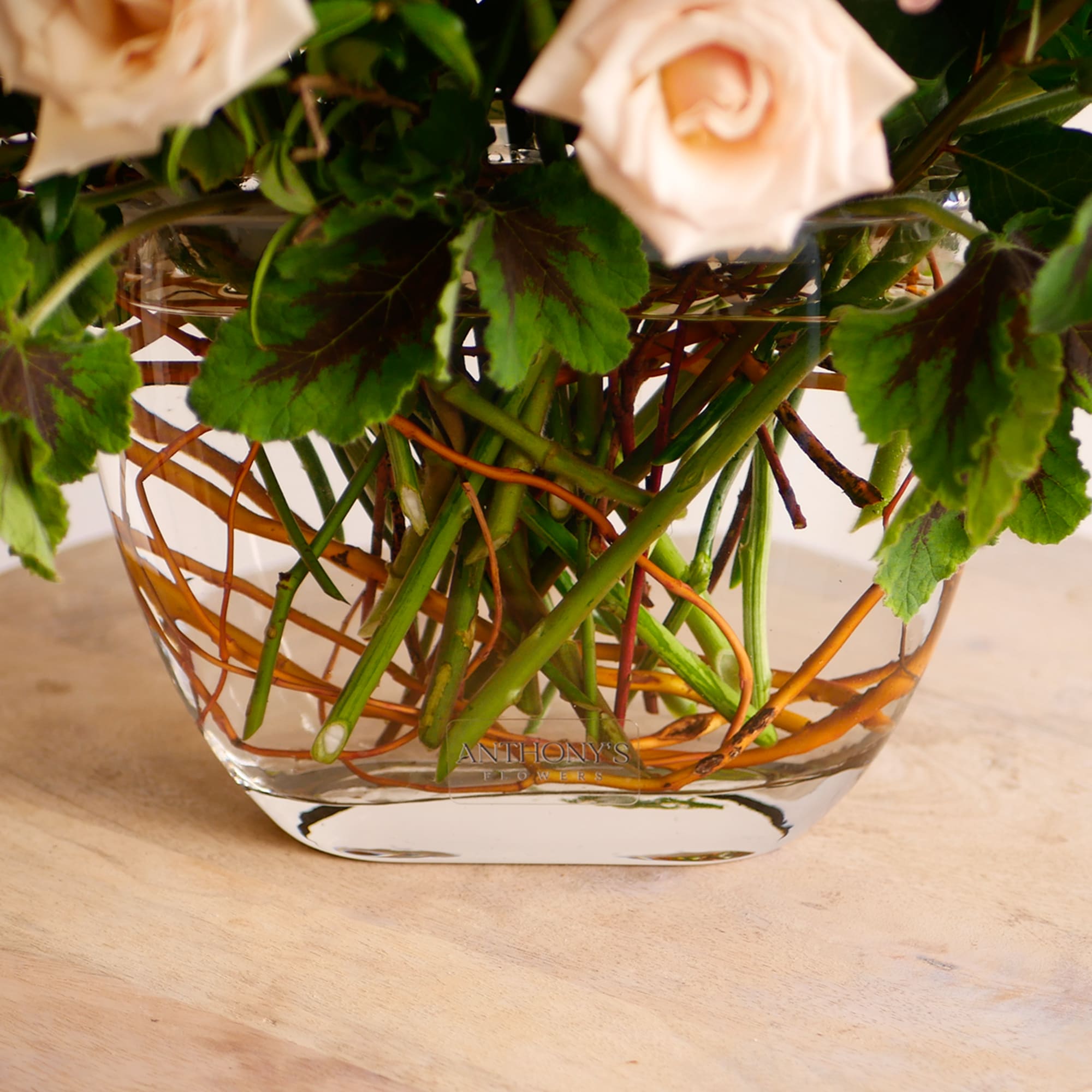 This fun garden-style arrangement displays a premium collection of pale pink and