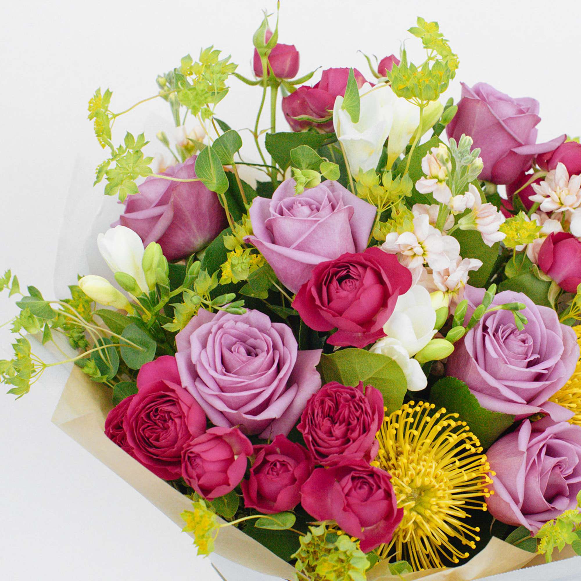 BOUQUET WITH LAVENDER ROSES, PINCUSHION PROTEAS &amp; FREESIAS 

Bright and fragrant. A