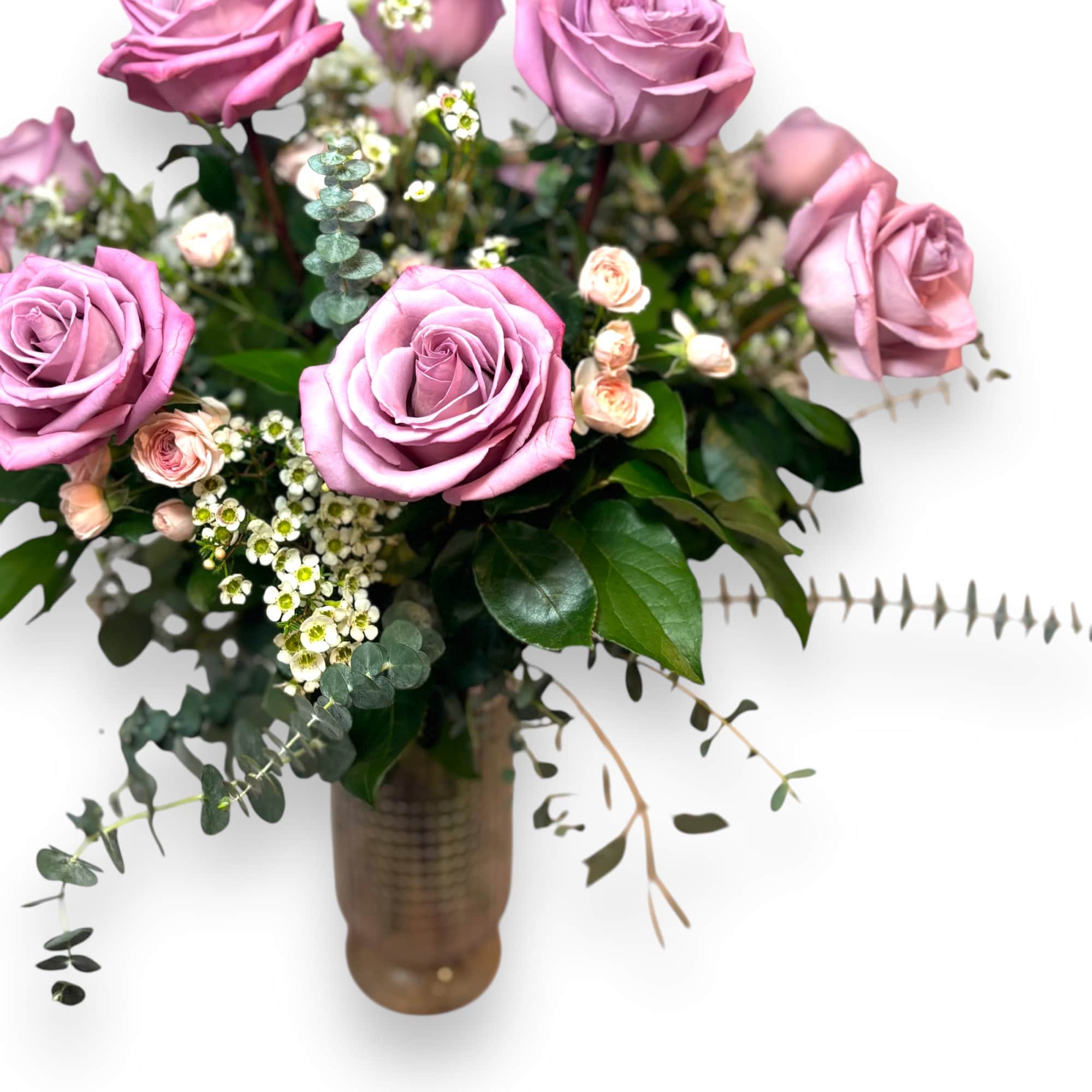 A dozen fragrant long stem lavender roses in pink vase accented with