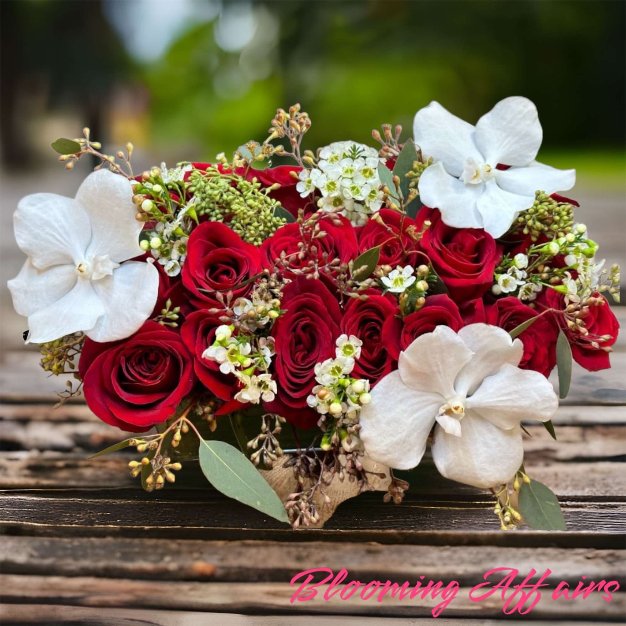 Red roses with orchids..