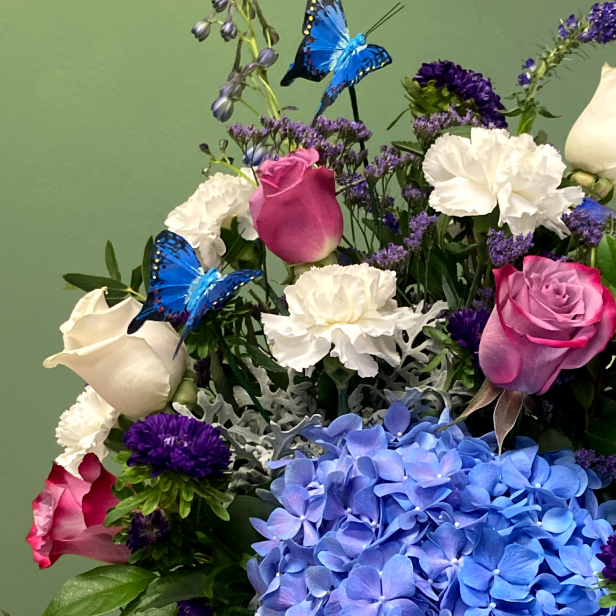 A striking mixed arrangement that showcases vibrant hues of purple, lavender, and