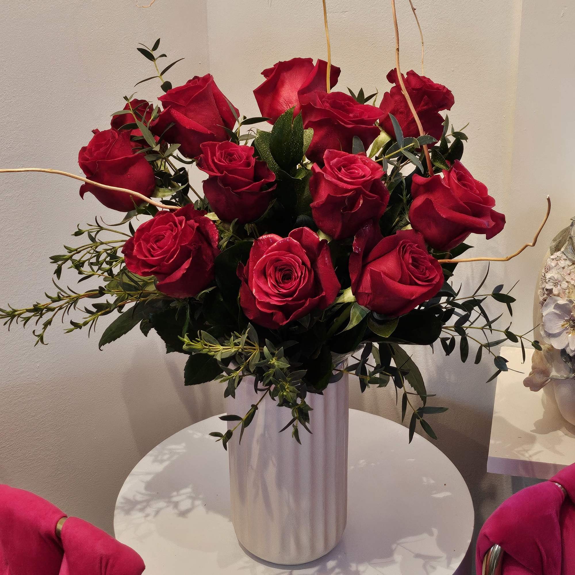  A simple but elegant display of vibrant red roses. Arranged with
