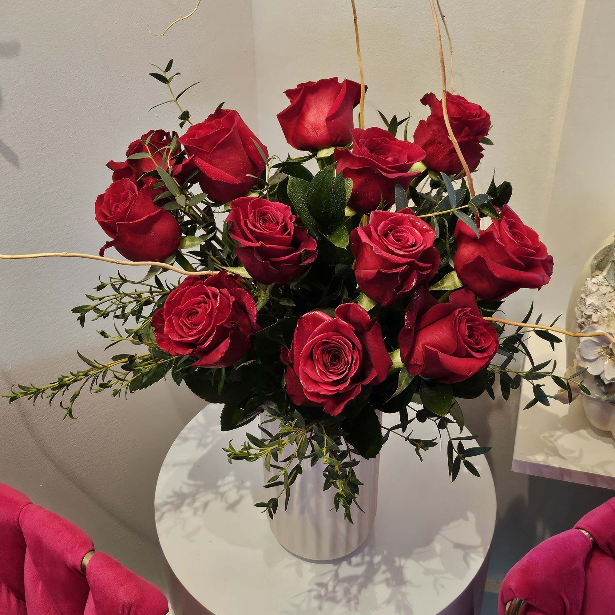  A simple but elegant display of vibrant red roses. Arranged with