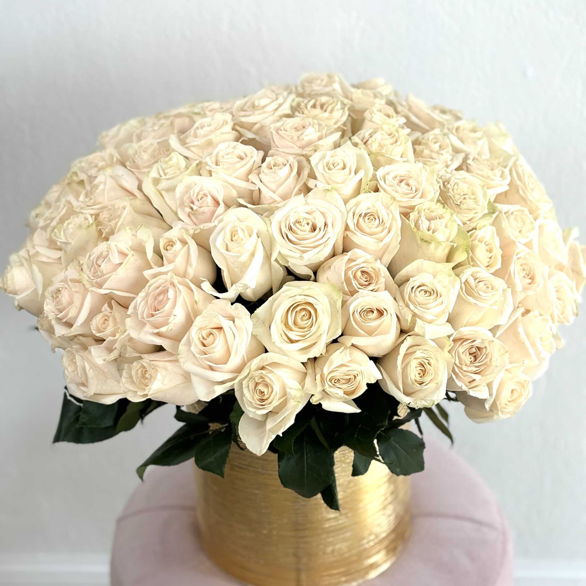 Beautiful golden vase filled with white roses
