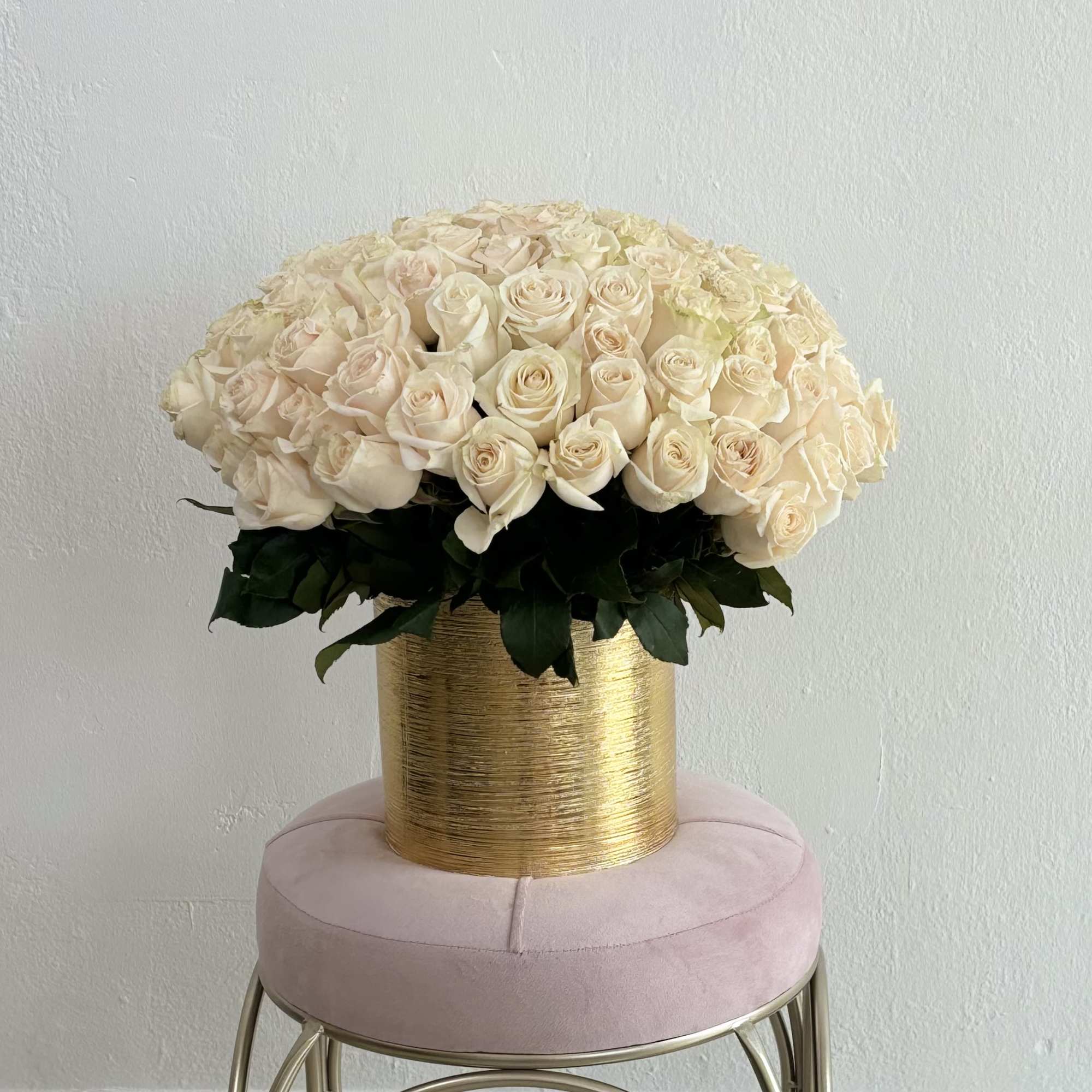 Beautiful golden vase filled with white roses
