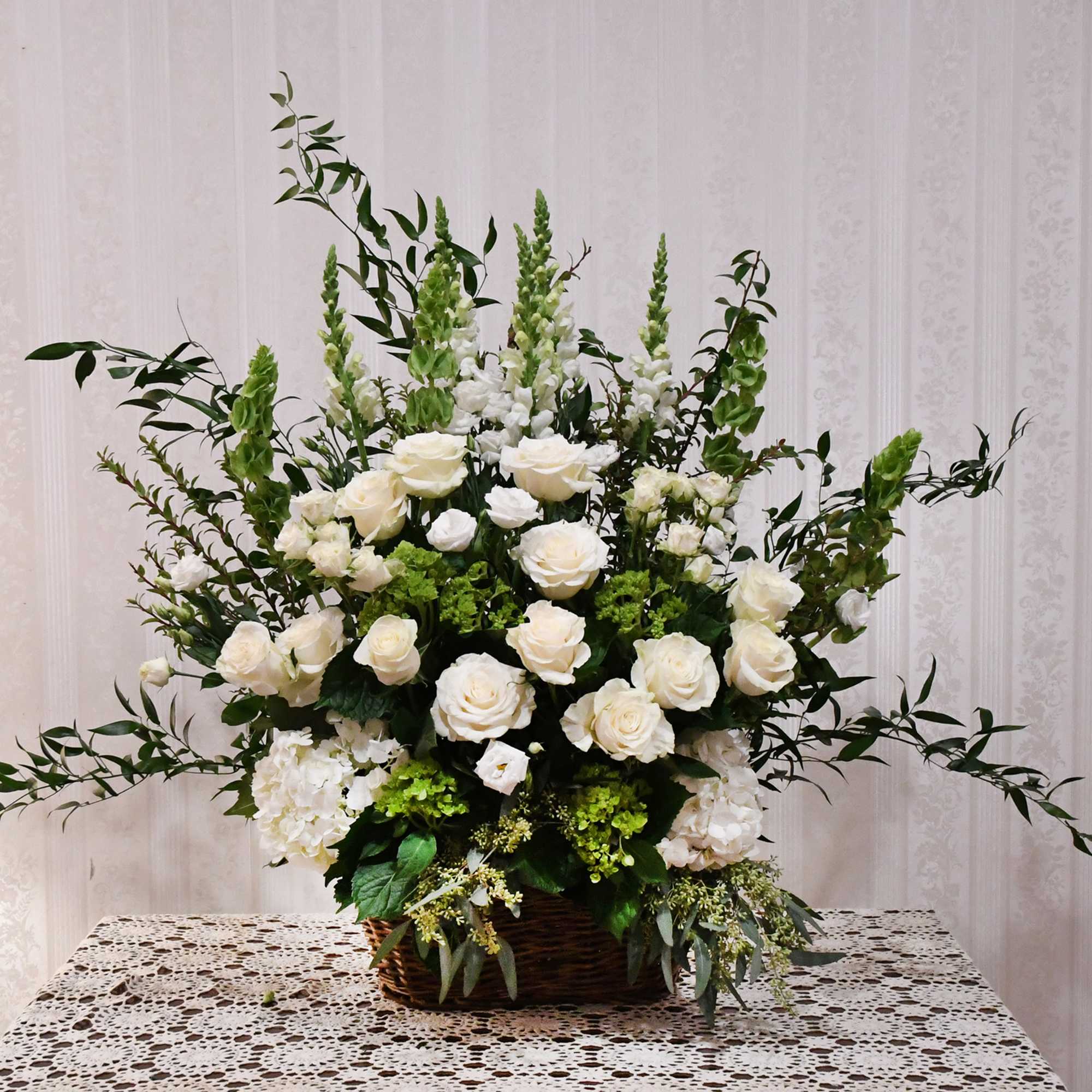 A beautiful tribute of classic white blooms.  Elegant roses, hydrangeas, snapdragons A beautiful tribute of classic white blooms.  Elegant roses, hydrangeas, snapdragons