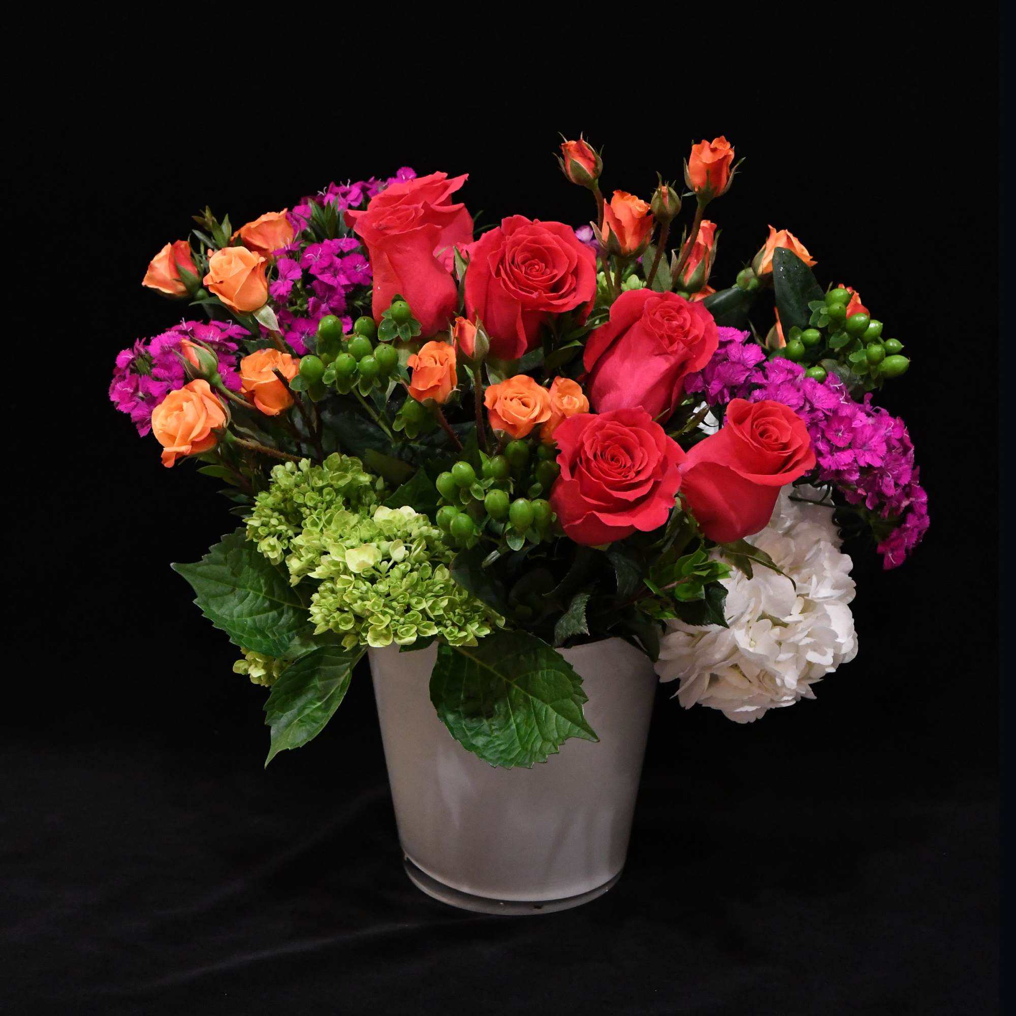 A gorgeous array of bright blooms.  Designed in a short, white A gorgeous array of bright blooms.  Designed in a short, white