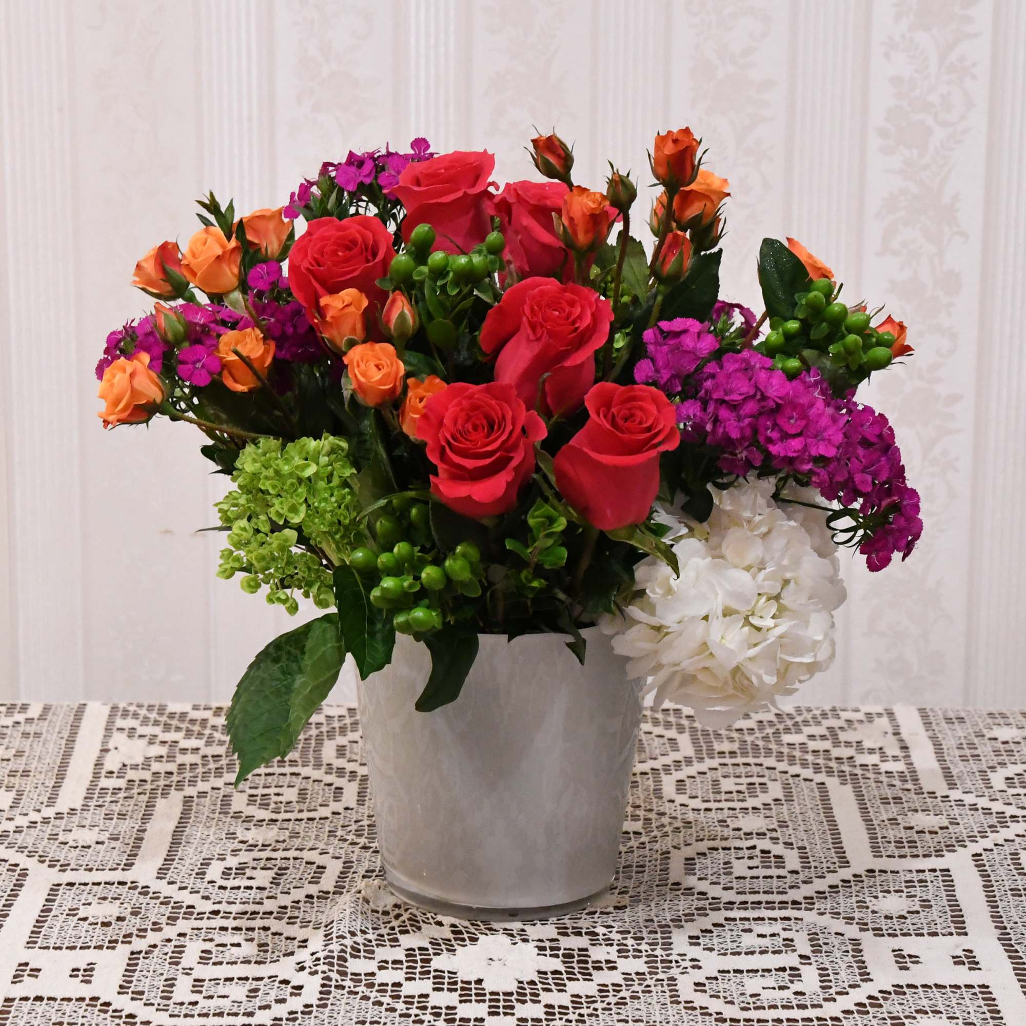 A gorgeous array of bright blooms.  Designed in a short, white A gorgeous array of bright blooms.  Designed in a short, white