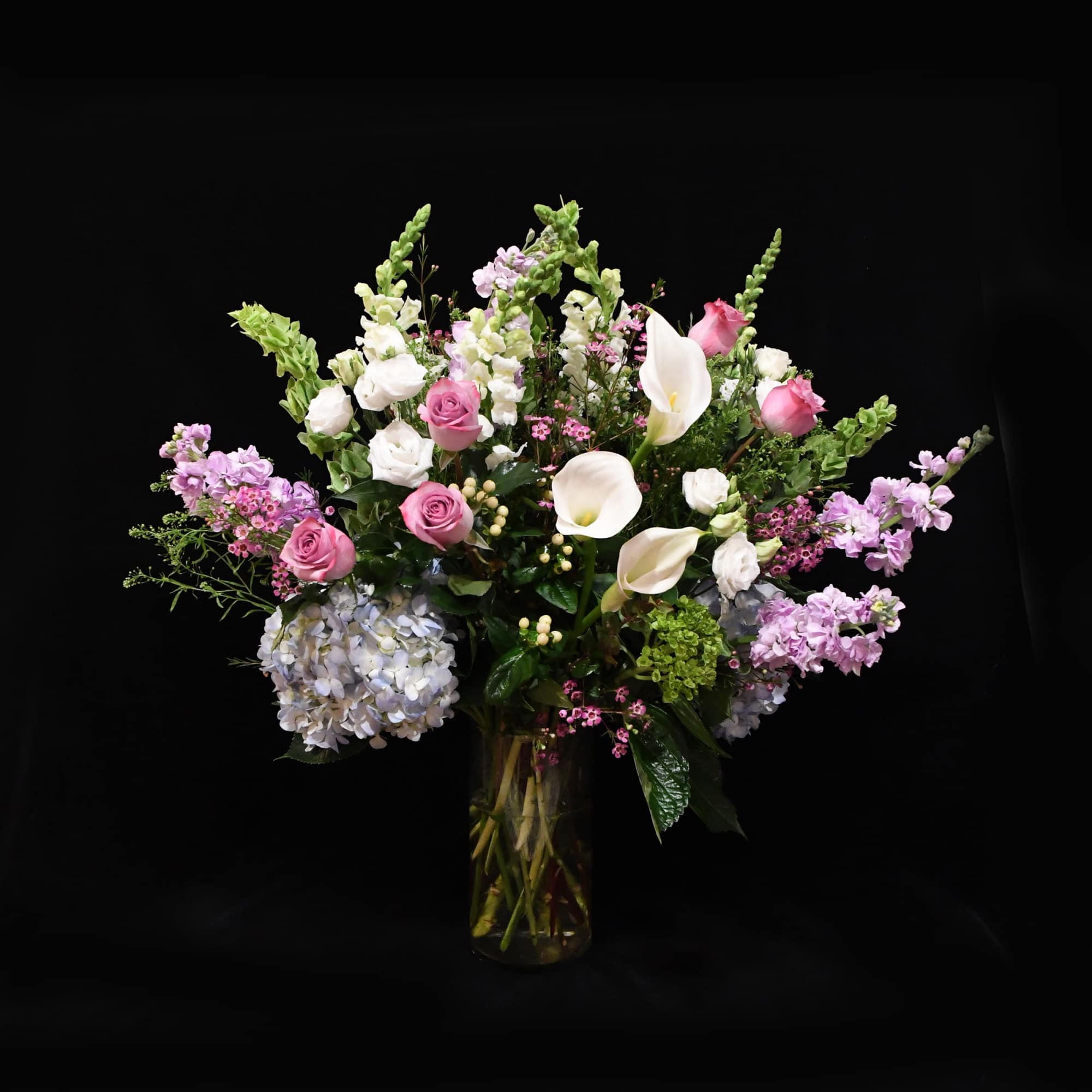 Elegant pastels and whites, arranged in a medium sized glass vase.  Elegant pastels and whites, arranged in a medium sized glass vase.