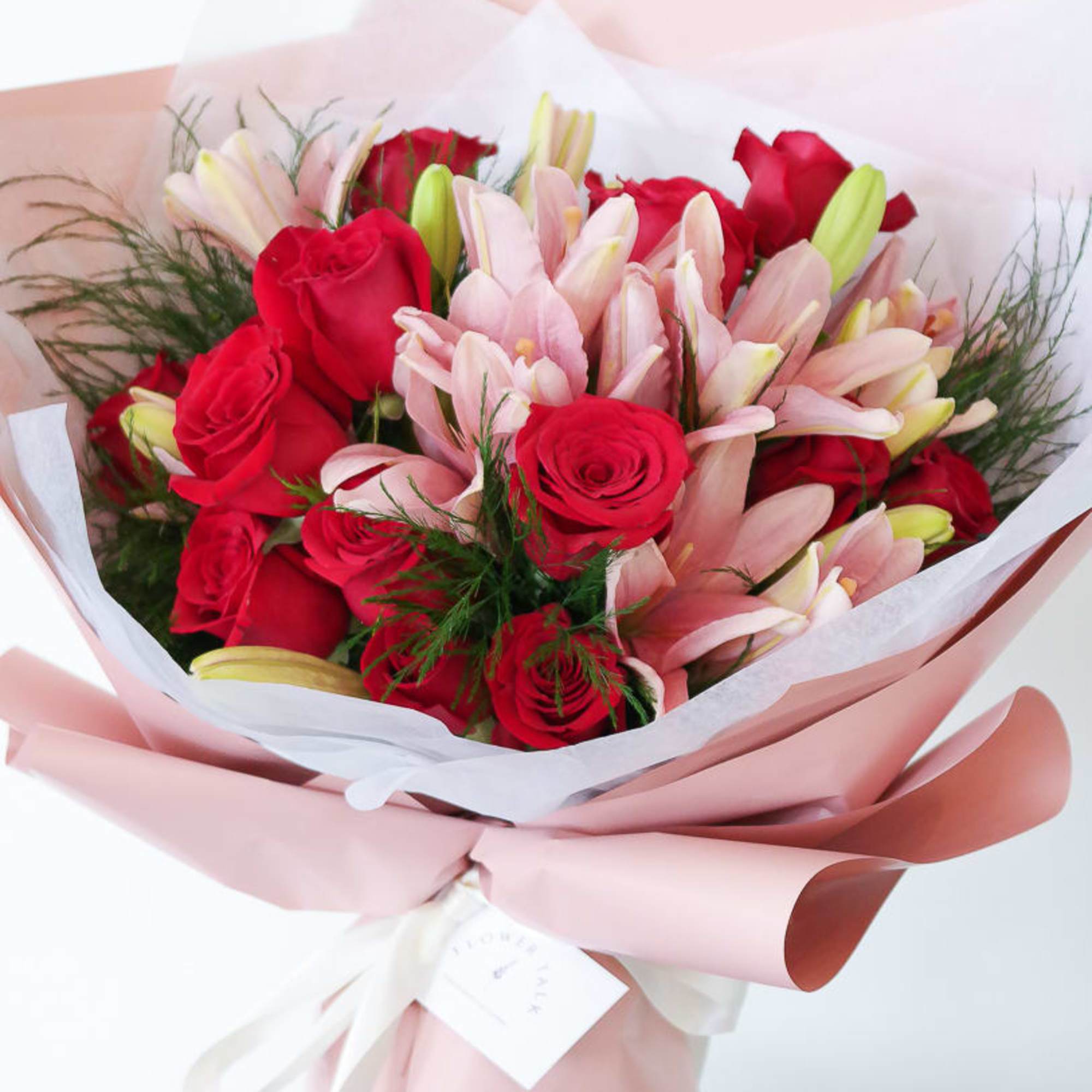 A mix of pink lilies and red roses dressed to impress! 
Note: A mix of pink lilies and red roses dressed to impress! 
Note: