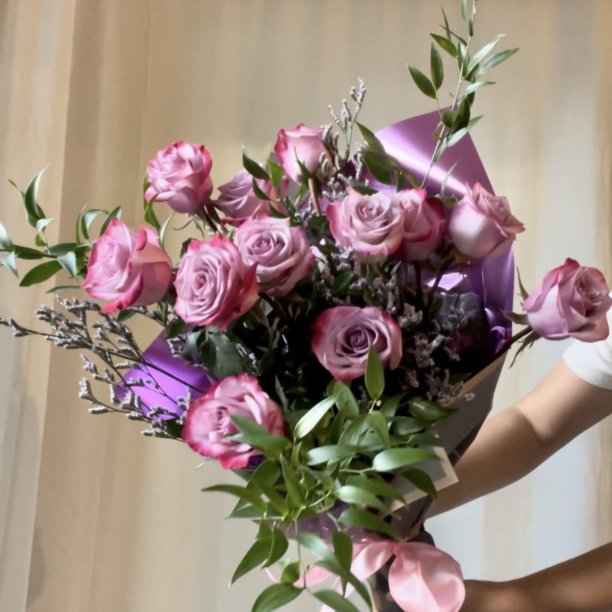 Featuring luxurious roses arranged in lush greenery, wrapped in premium paper and Featuring luxurious roses arranged in lush greenery, wrapped in premium paper and