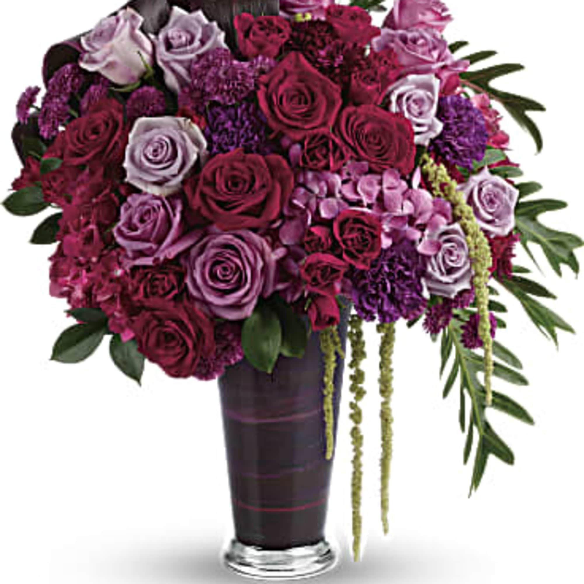 A dramatic display in jewel-toned roses and hydrangea in a sophisticated vase