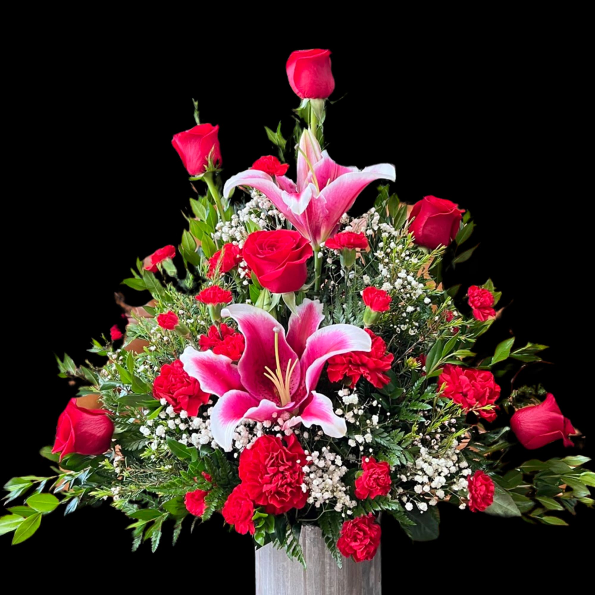 Rustic red container displaying a mix of high quality long stem roses