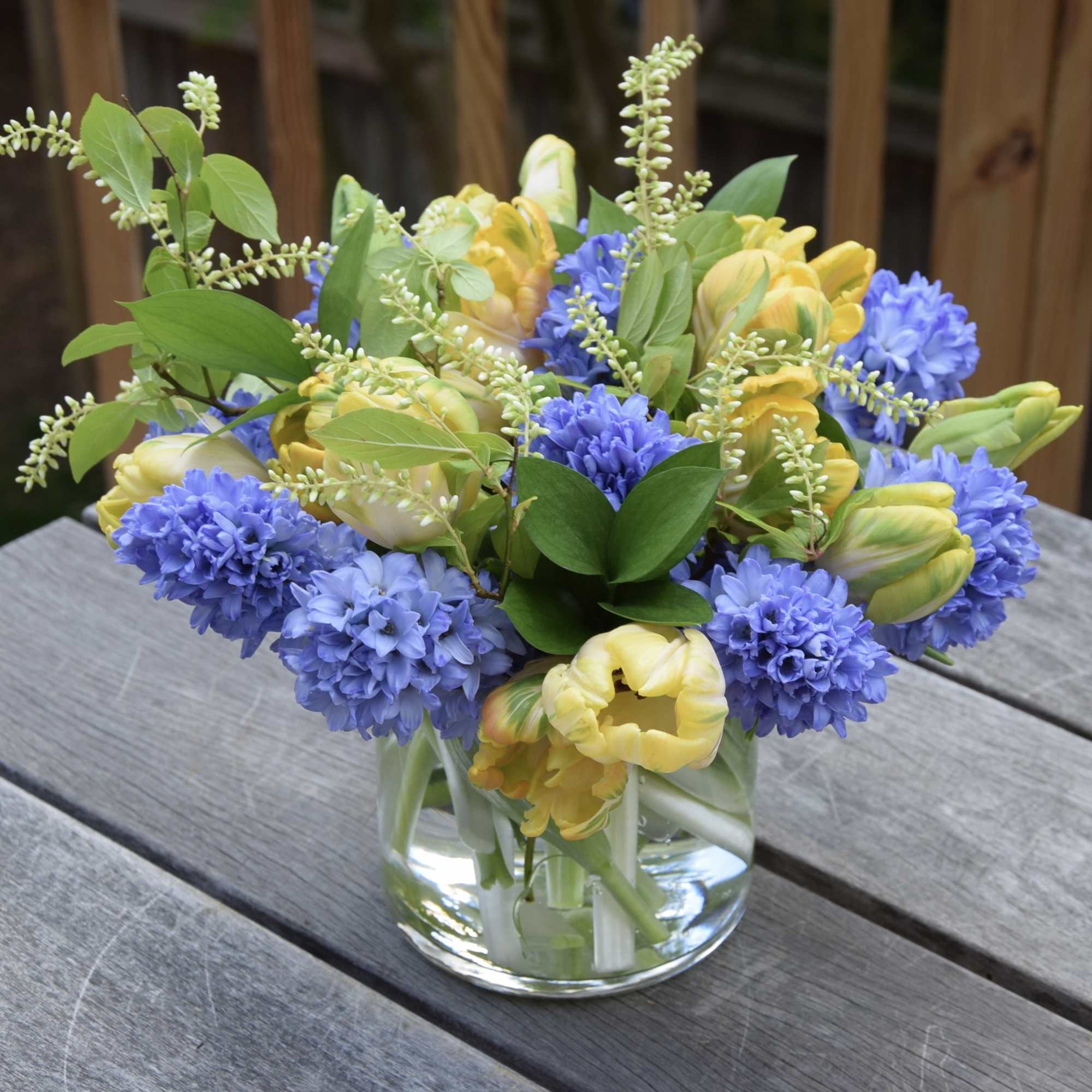 A simple elegant flower arrangement of fragrant hyacinths and tulips, with greenery