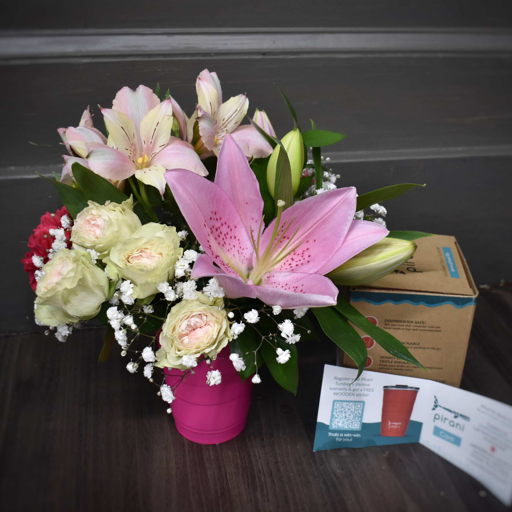 A refreshing bouquet of flowers in an insulated party tumbler By Pirani. A refreshing bouquet of flowers in an insulated party tumbler By Pirani.