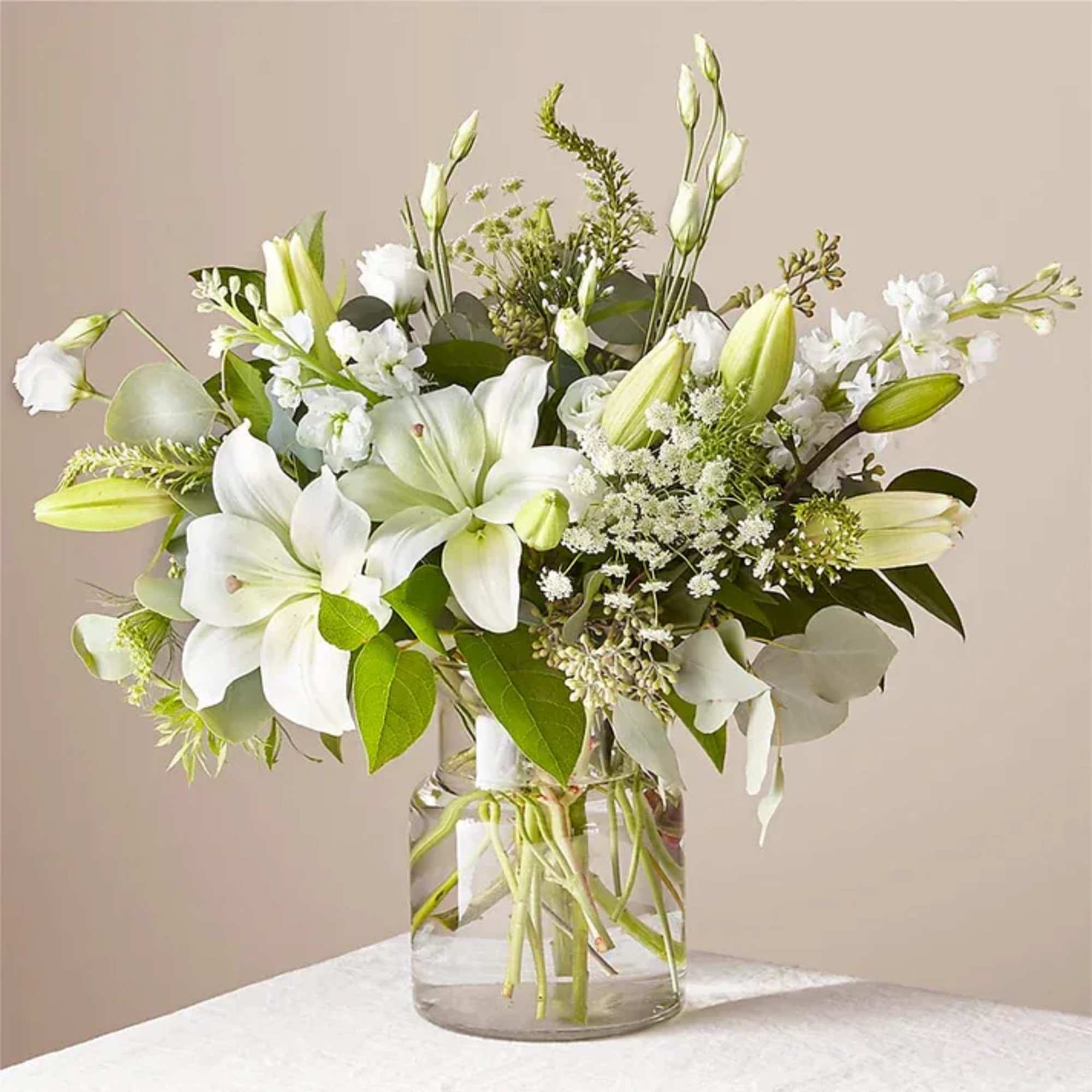A stunning arrangement of fresh Asiatic lilies, white Veronica, white stock, Queen
