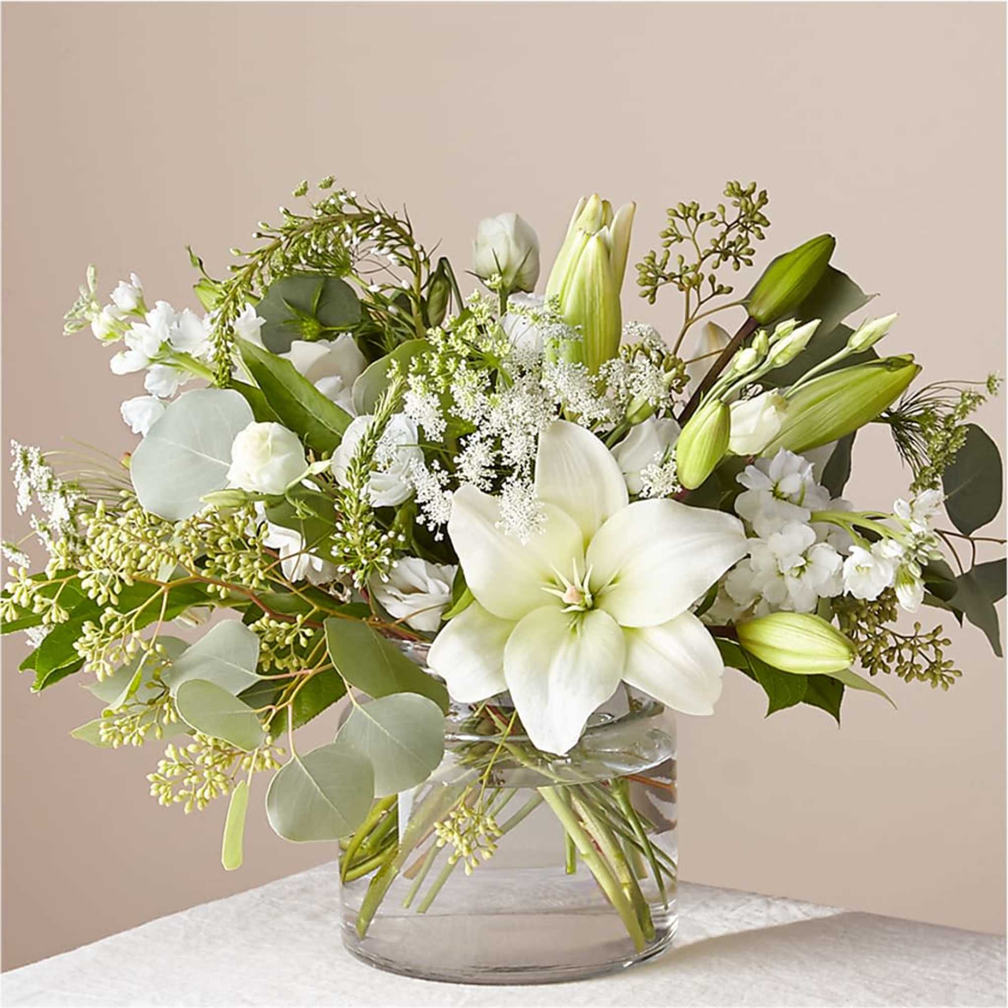 A stunning arrangement of fresh Asiatic lilies, white Veronica, white stock, Queen