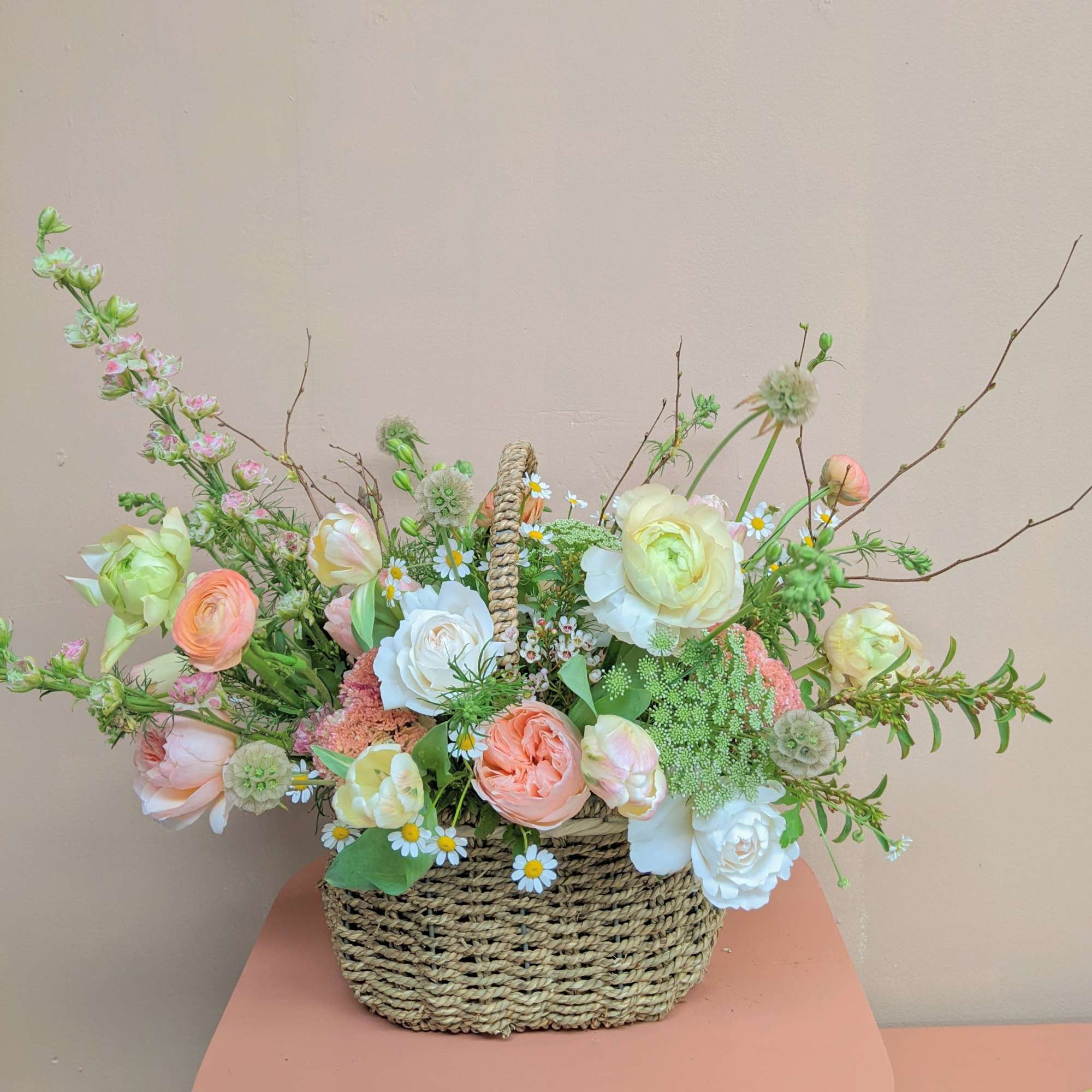 A natural style basket with a handle full of all the pretty