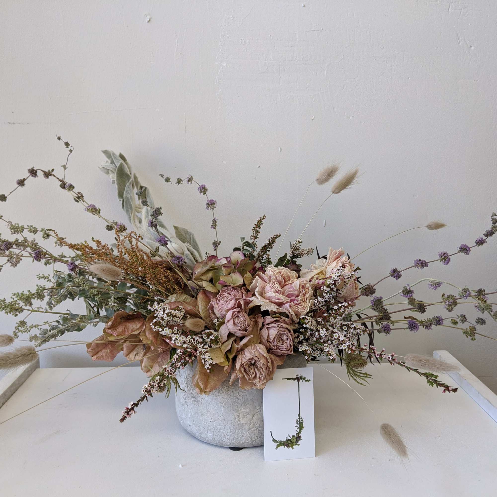 This everlasting dried arrangement includes dried Peonies and comes in a cement